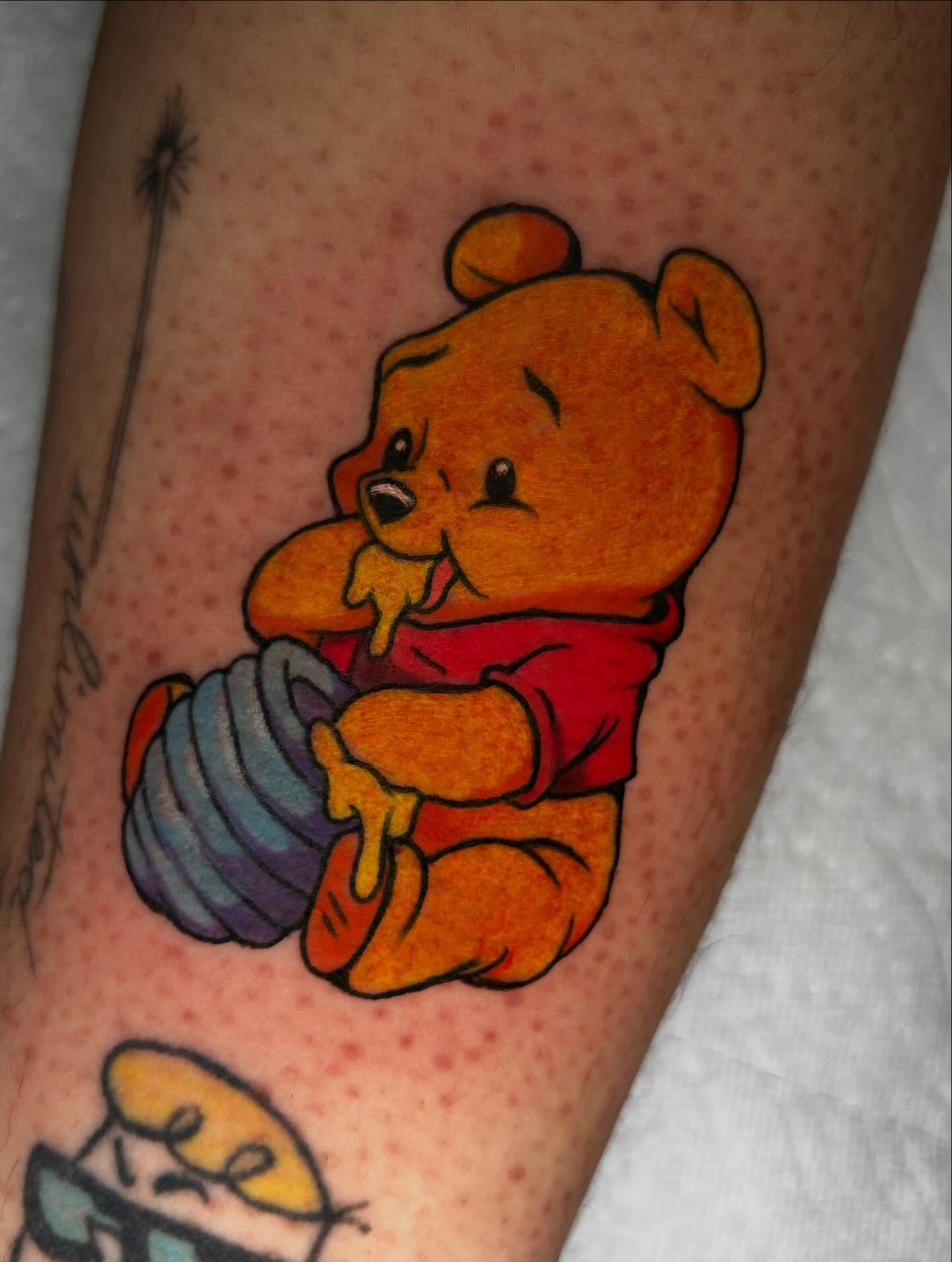 Winnie the Pooh illustrative tattoo on the thigh by ✶ 𝓑𝓲𝓽𝓮𝓼𝓲𝔃𝓮𝓭 𝓘𝓷𝓴 ✶, Buford, Georgia