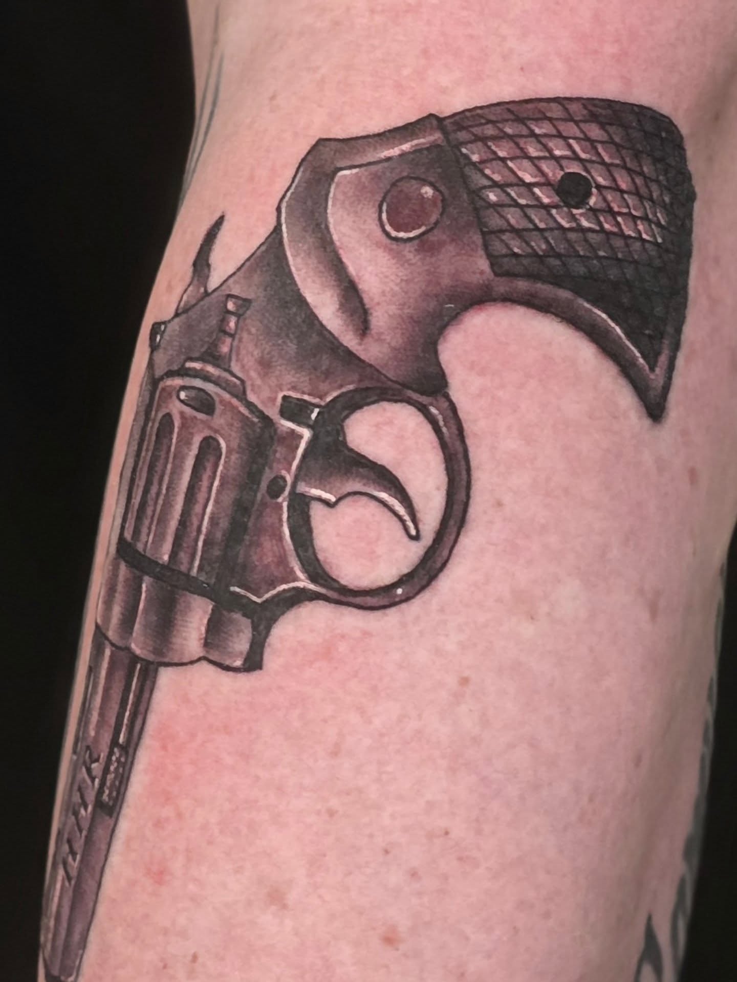 Revolver black and grey tattoo on the forearm by Steve Atkinson Tattoo Artist