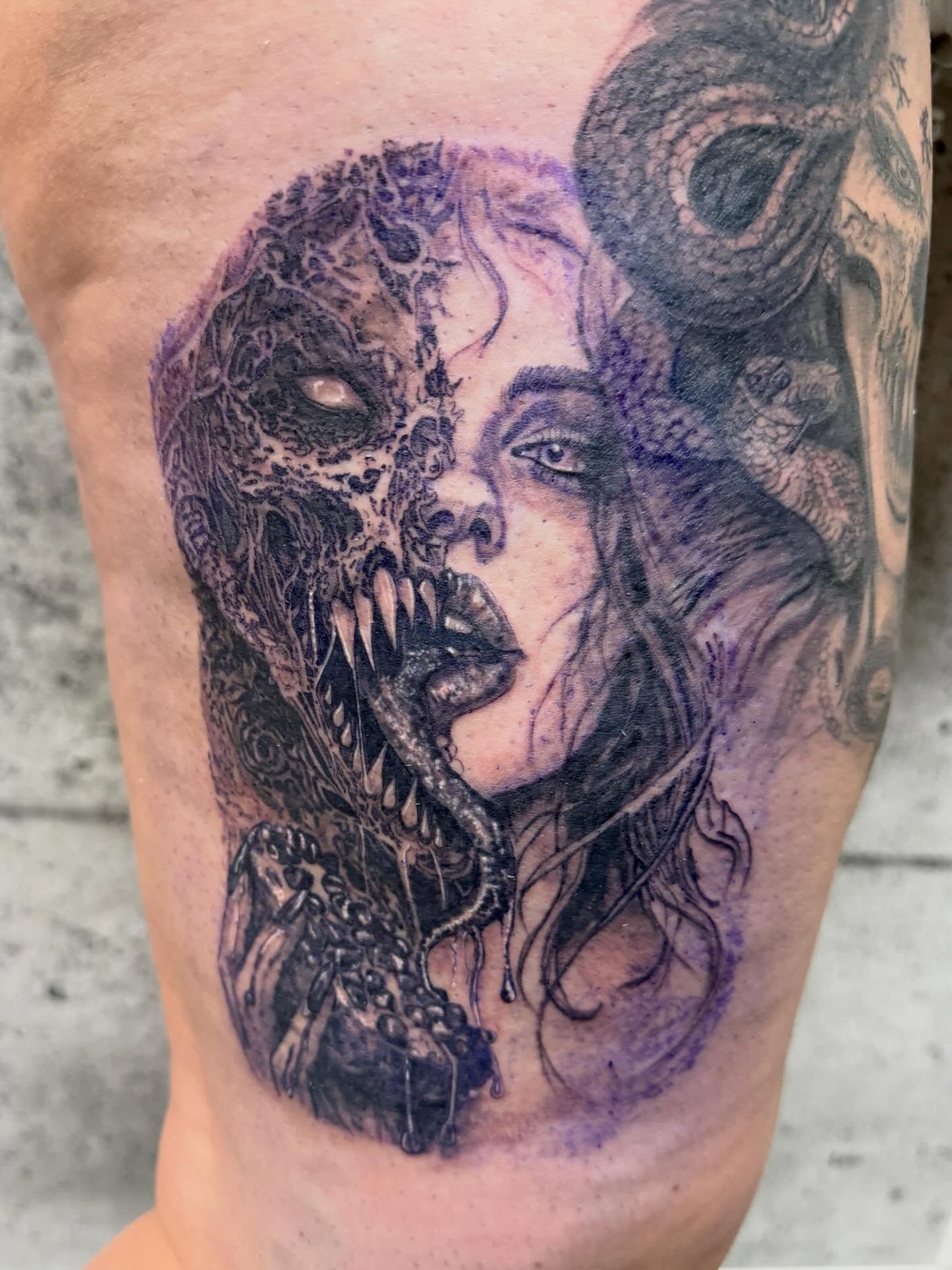Woman with monster dark realism tattoo on the forearm by Aura Noire