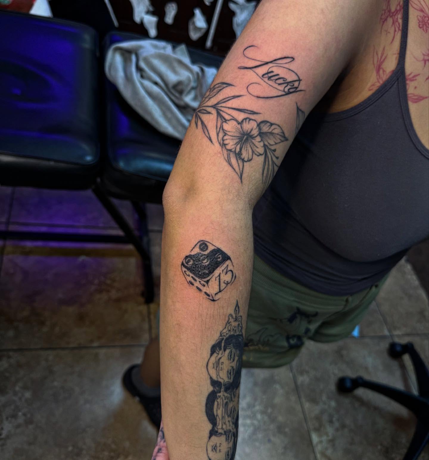 Dice black and grey tattoo on the forearm by McKenna Hughes