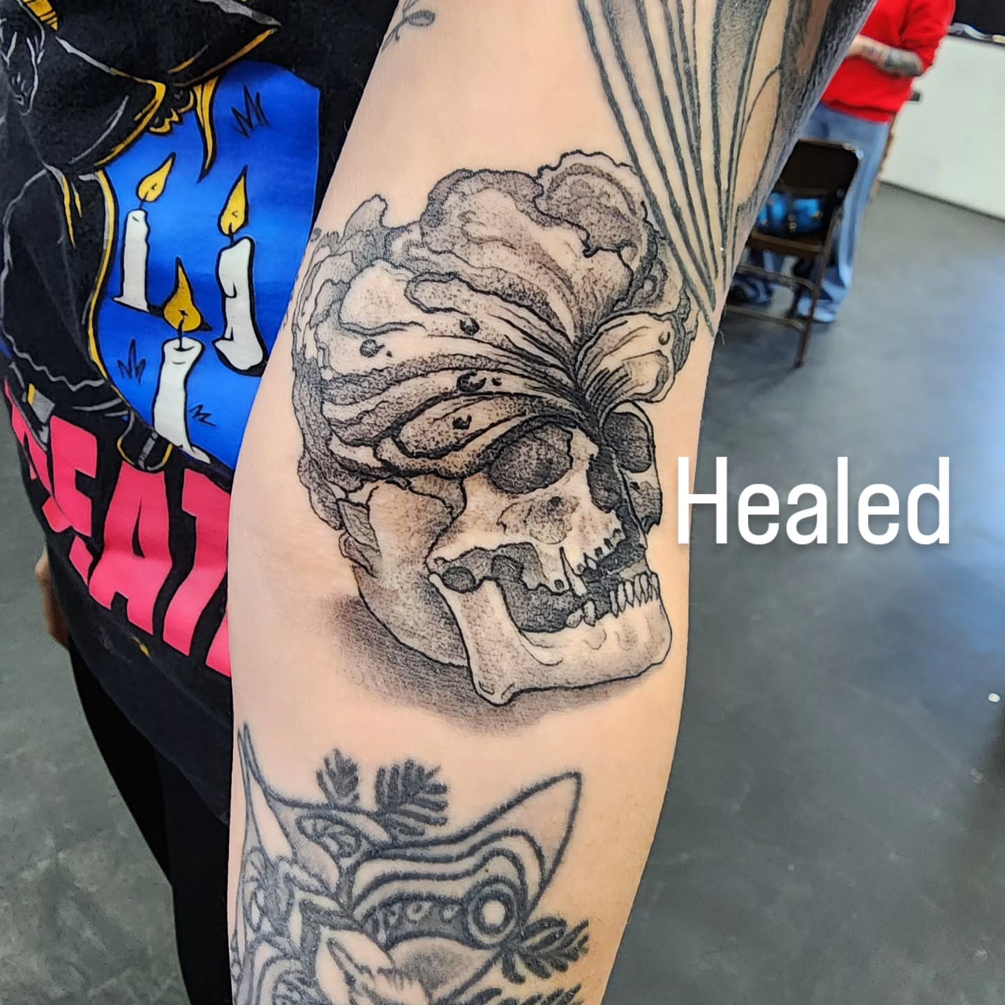 Skull with flower dotwork tattoo on the forearm by Robert Glover