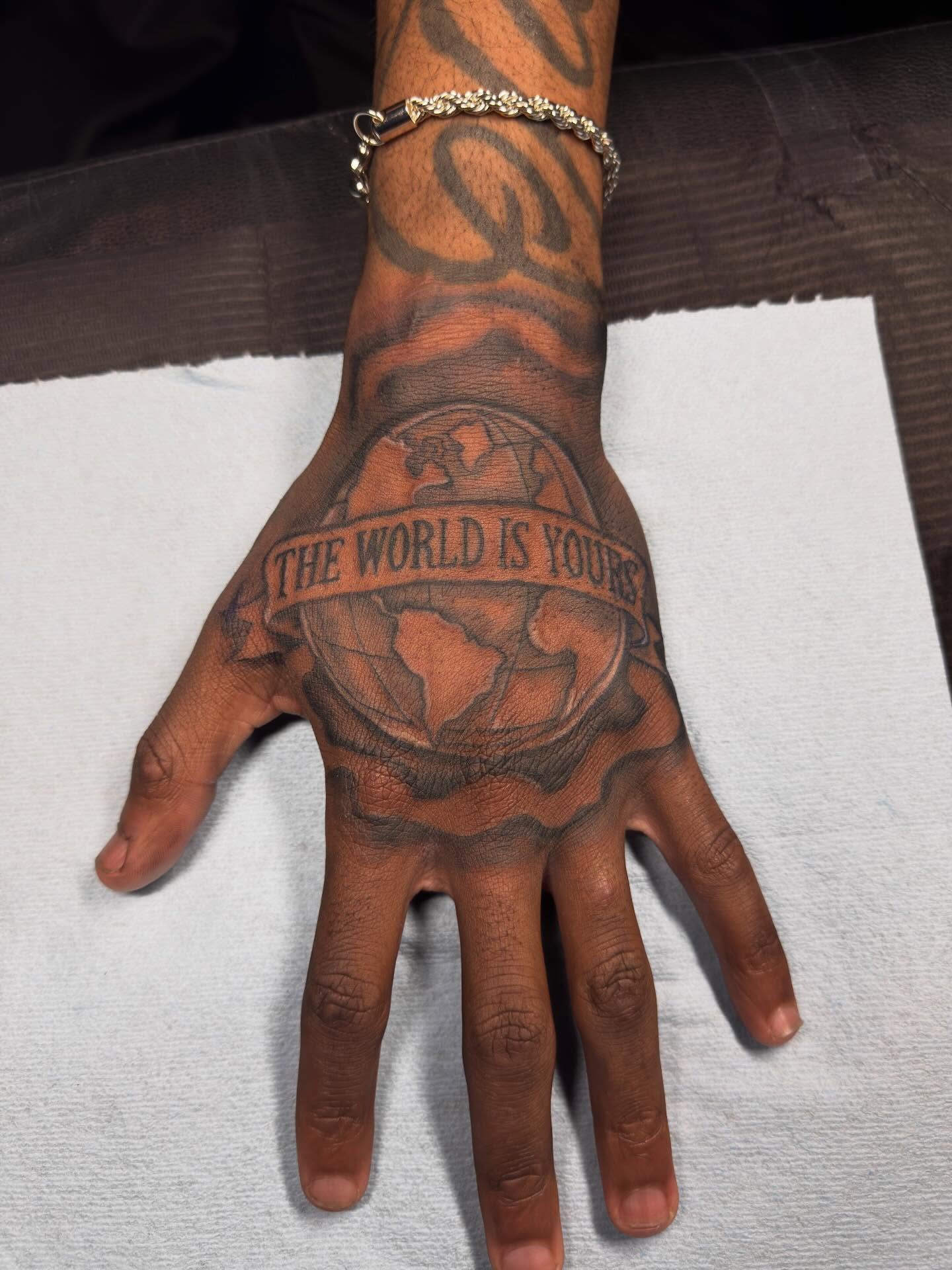 World map black and grey tattoo on the hand by dallas tattoo artist, Duncanville, Texas