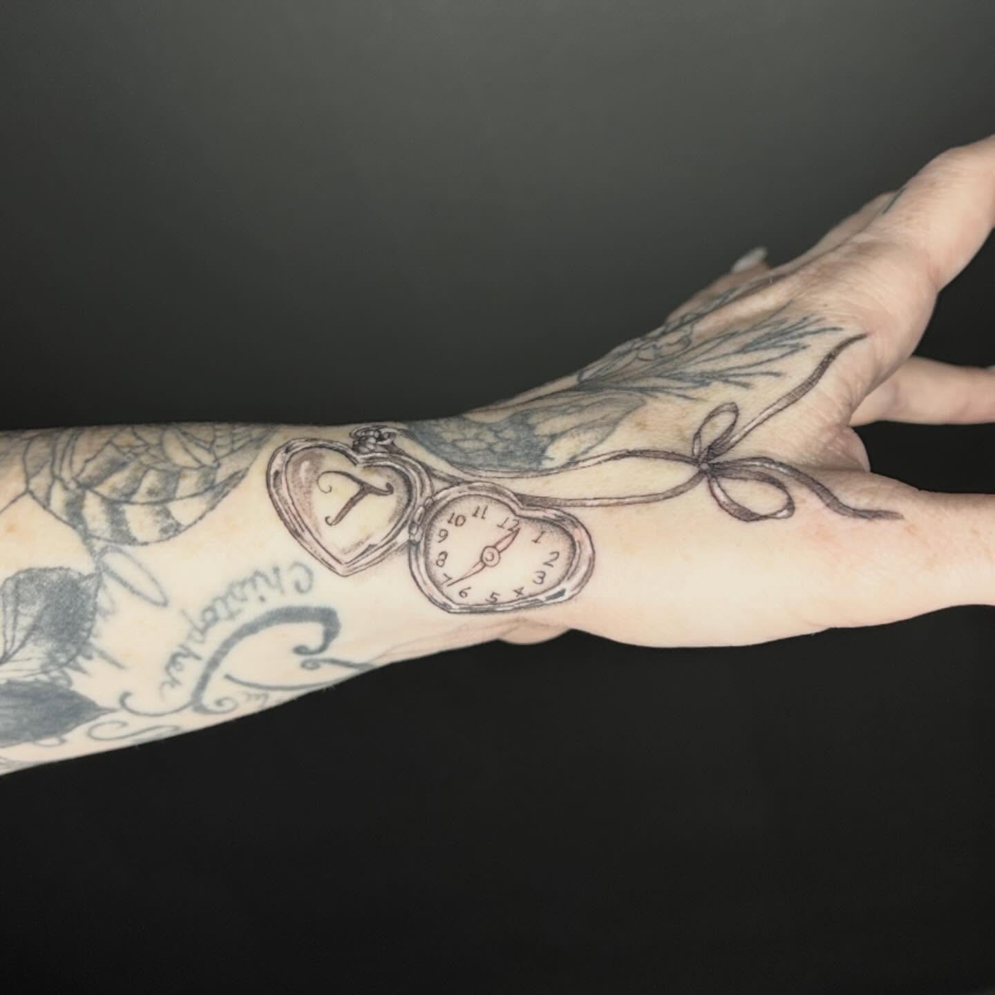 Heart-shaped pocket watch black and grey tattoo on the forearm by Elizabeth (Lib), Murfreesboro, Tennessee