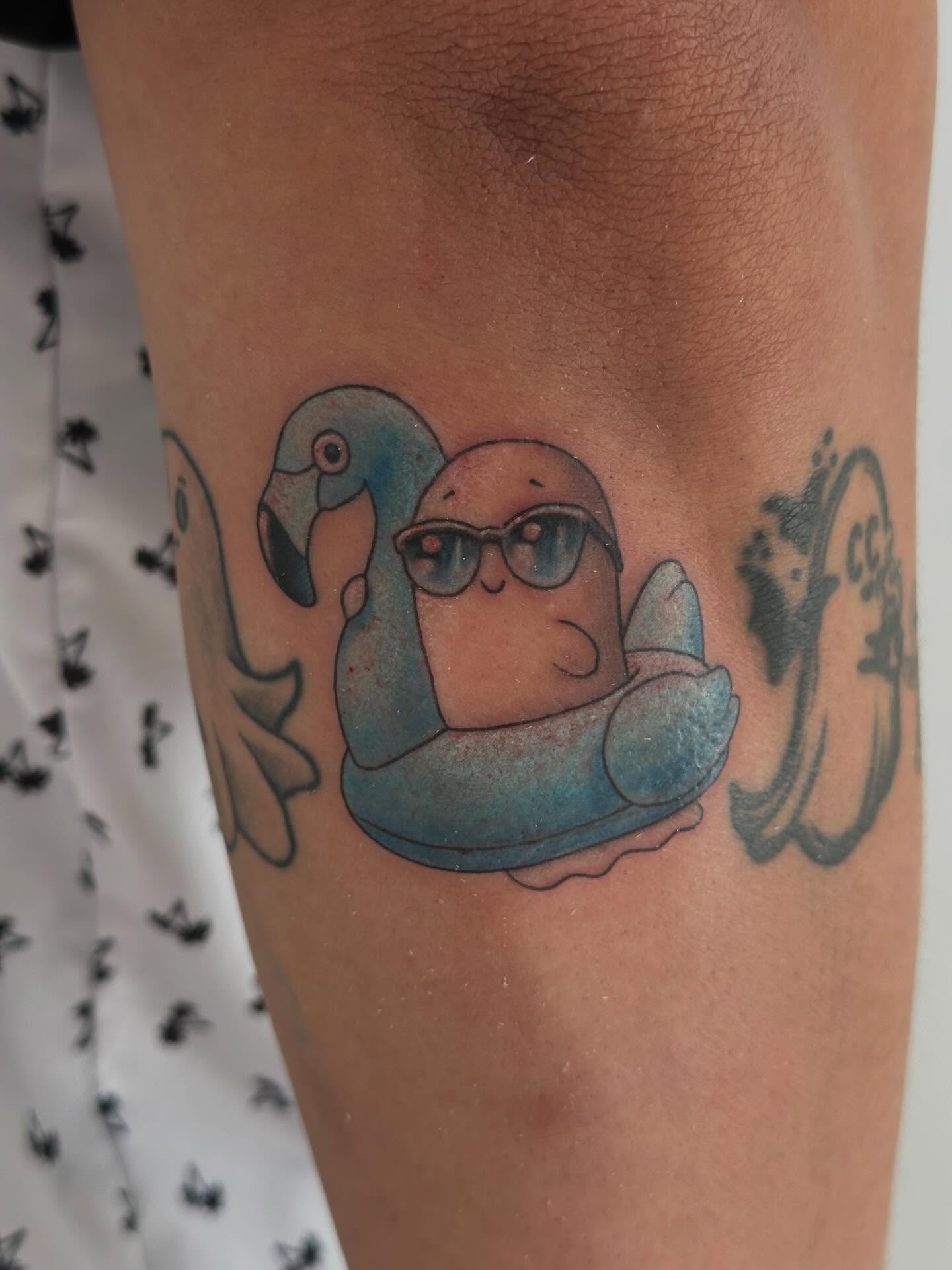 Parrot and penguin new school tattoo on the forearm by Winters Ashurst - St. George tattoo artist