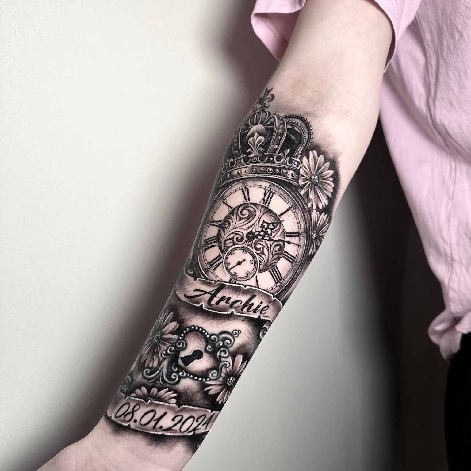 Clock and floral realism tattoo on the forearm by Tattoos By Josh