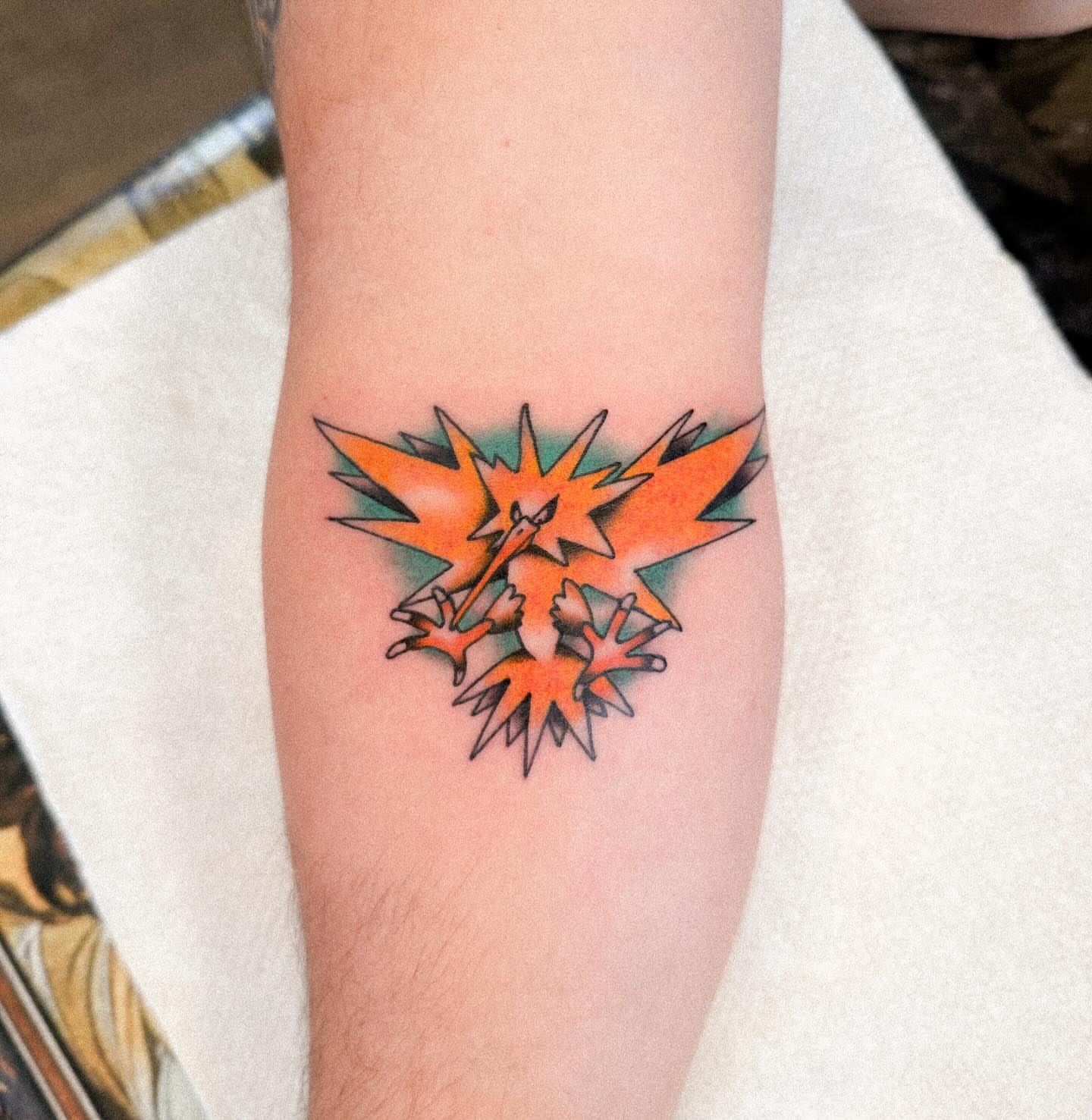 Ho-Oh anime tattoo on the forearm by Nathan Thomas