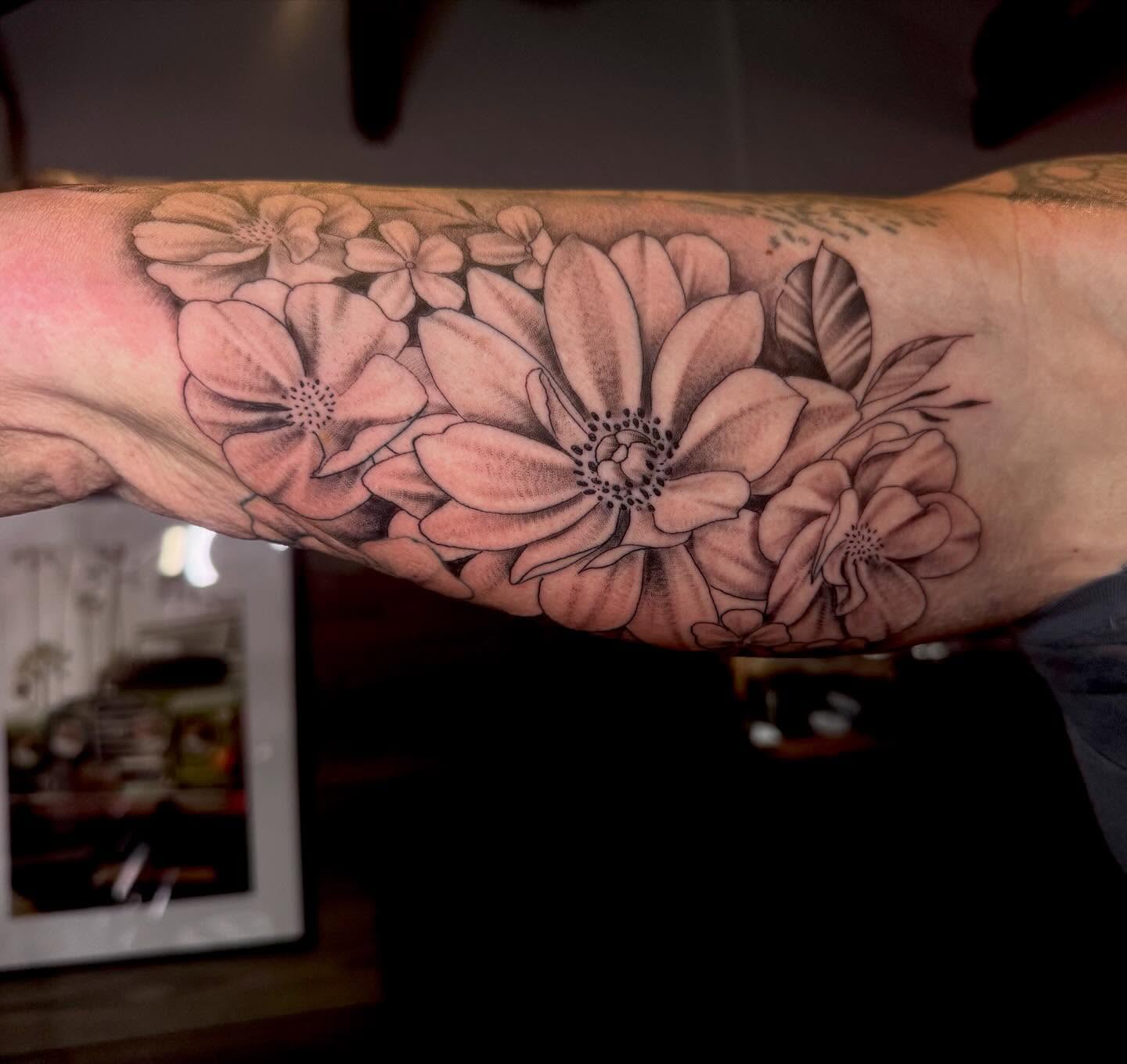 Flower bouquet black and grey tattoo on the forearm by Gabrielle Mack