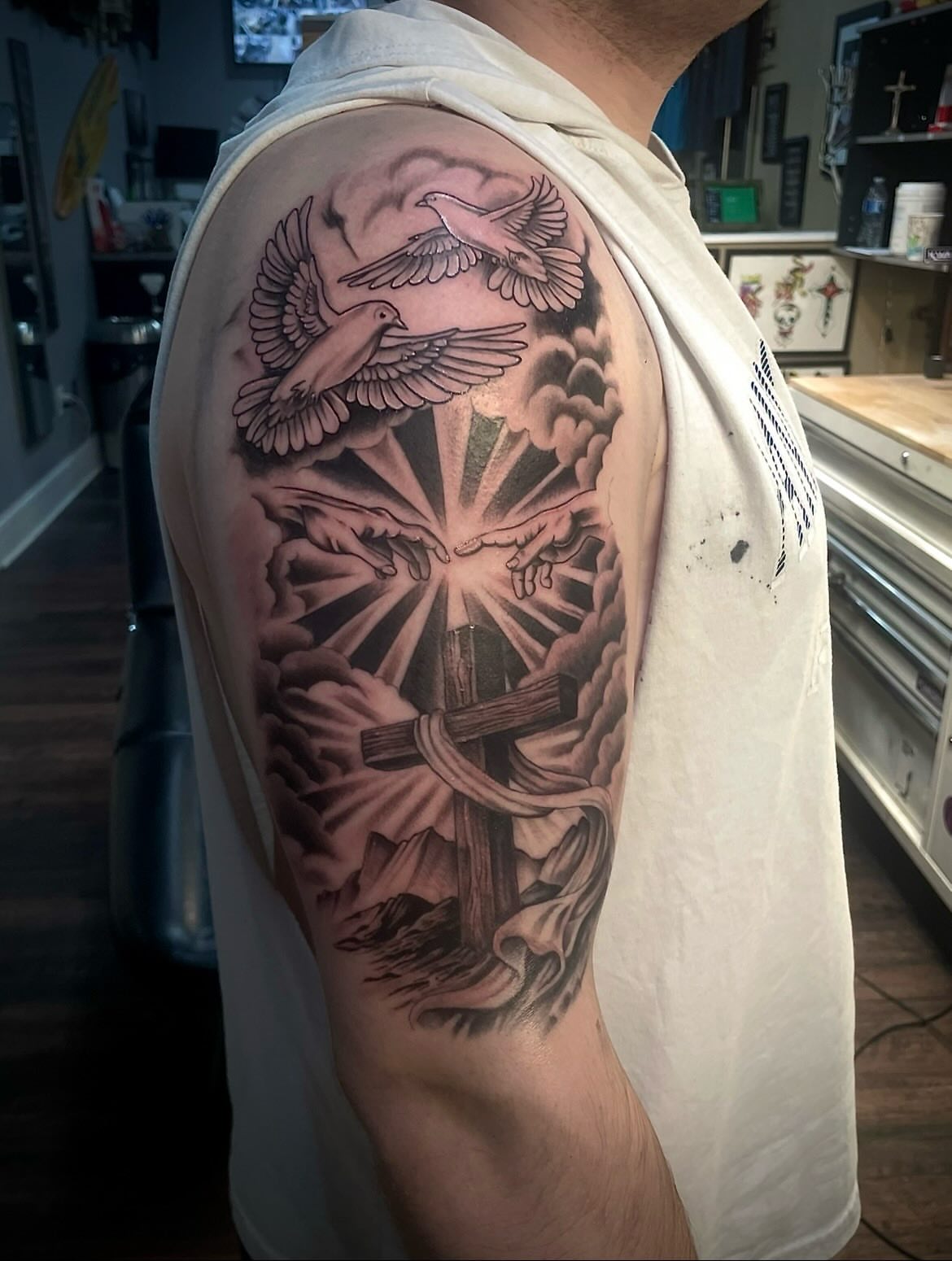 Religious cross and doves realism tattoo on the shoulder by π©Έβ βοΈ ππππ βοΈ βπ©Έ