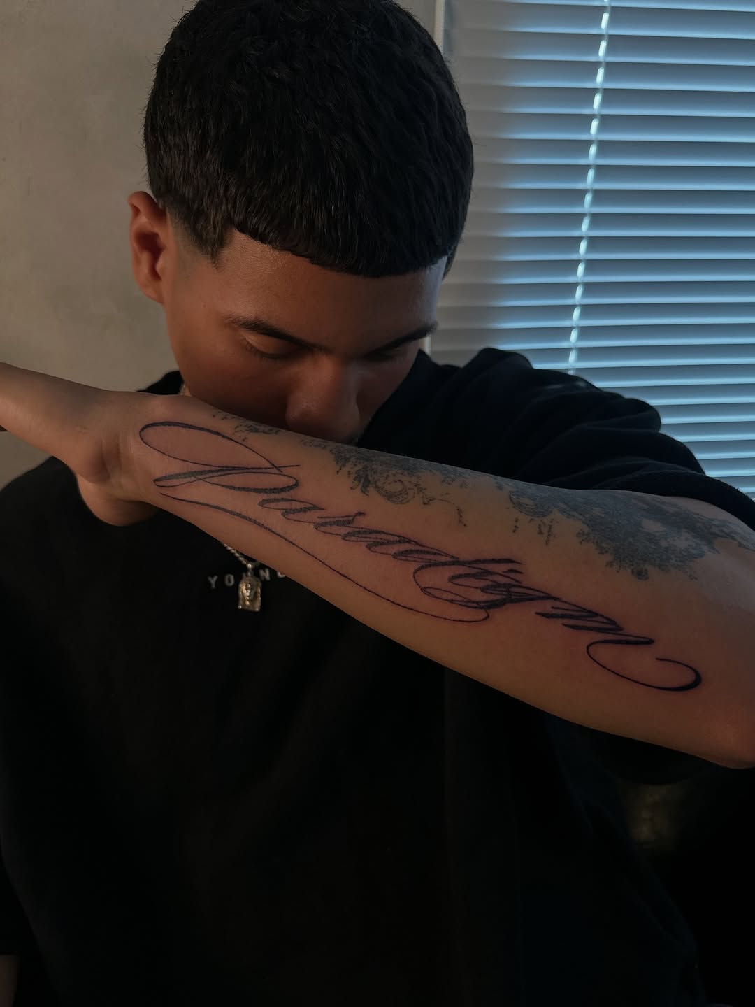 Script lettering lettering tattoo on the forearm by eyeball