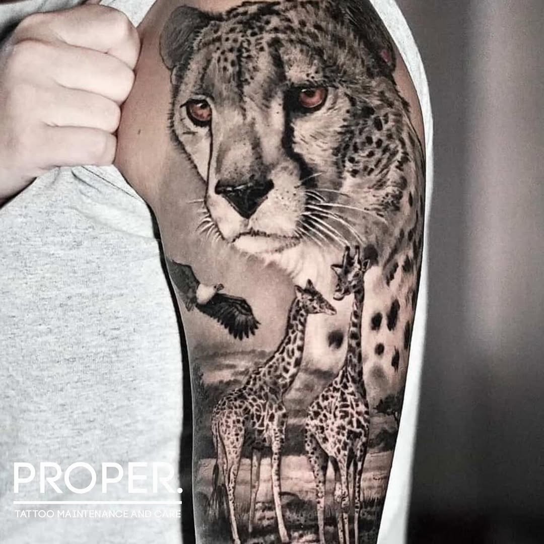 Cheetah and giraffes realism tattoo on the forearm by Joshua Phillips, Mansfield, Ohio