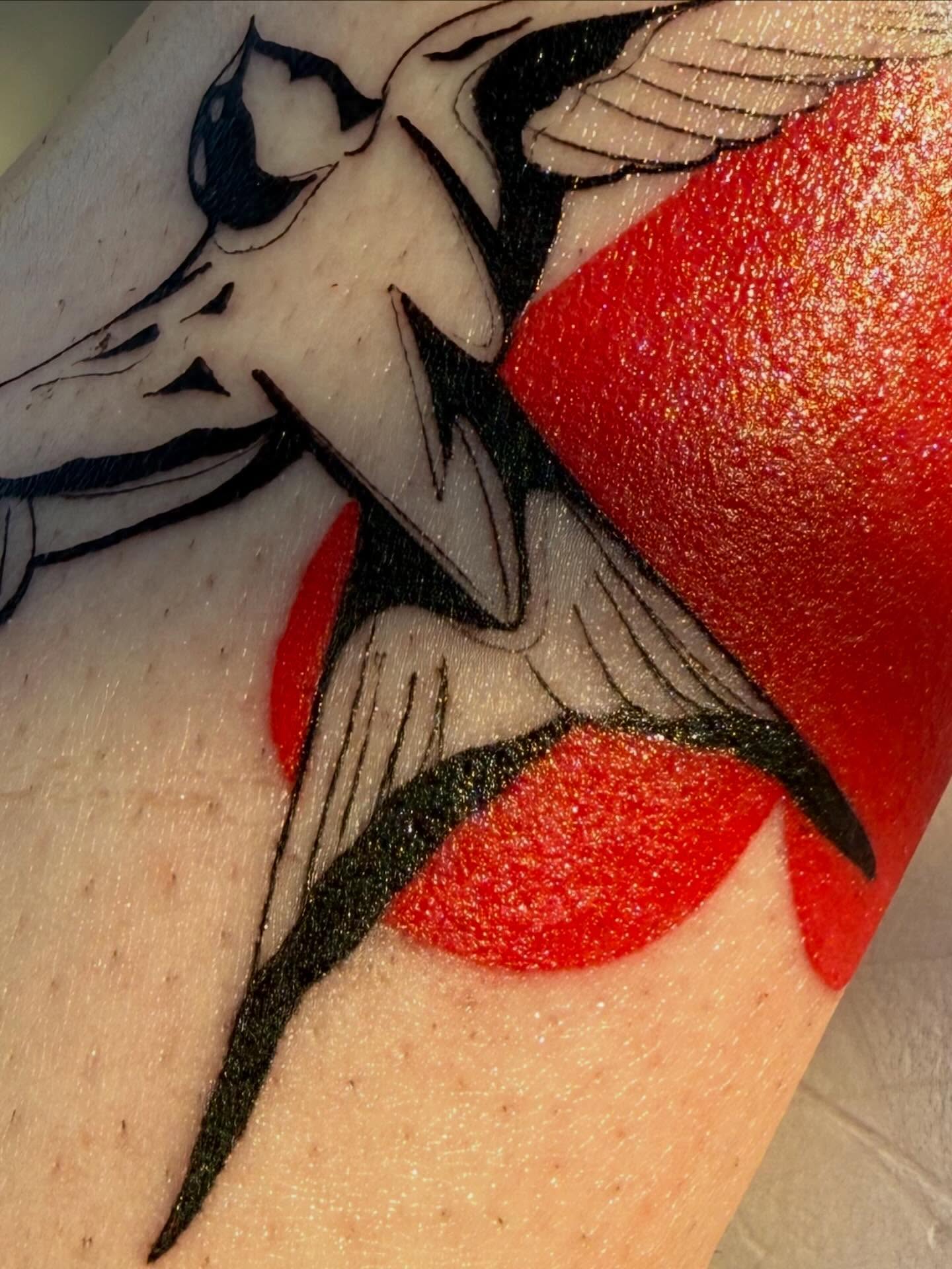 Bird and red shapes American traditional tattoo on the forearm by Michela's Tattoo's