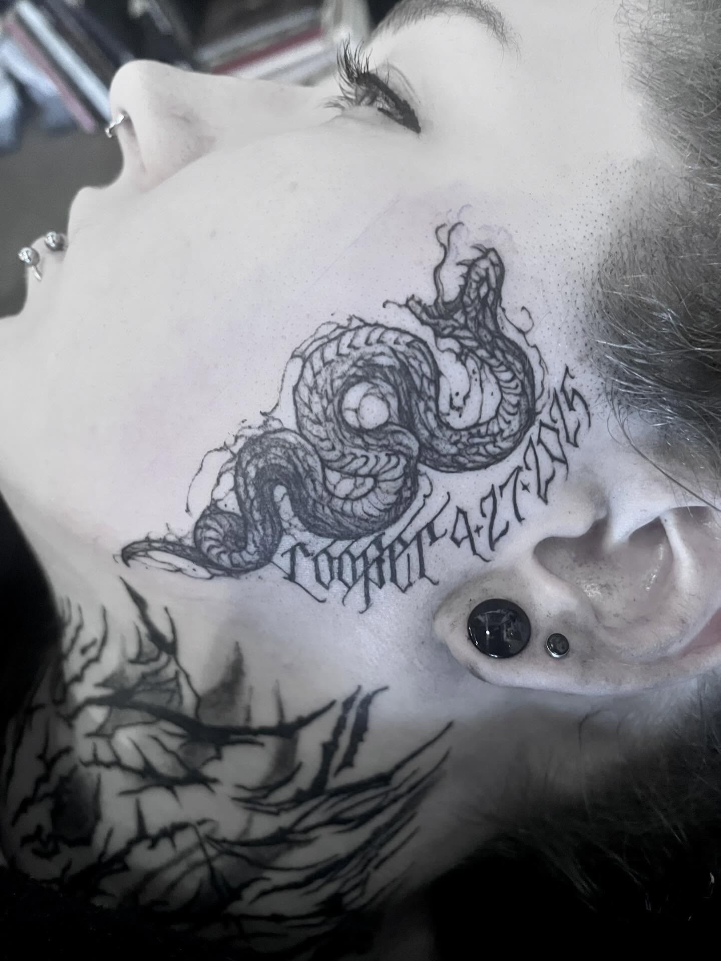 Serpent black and grey tattoo on the neck by Nathan Esteras