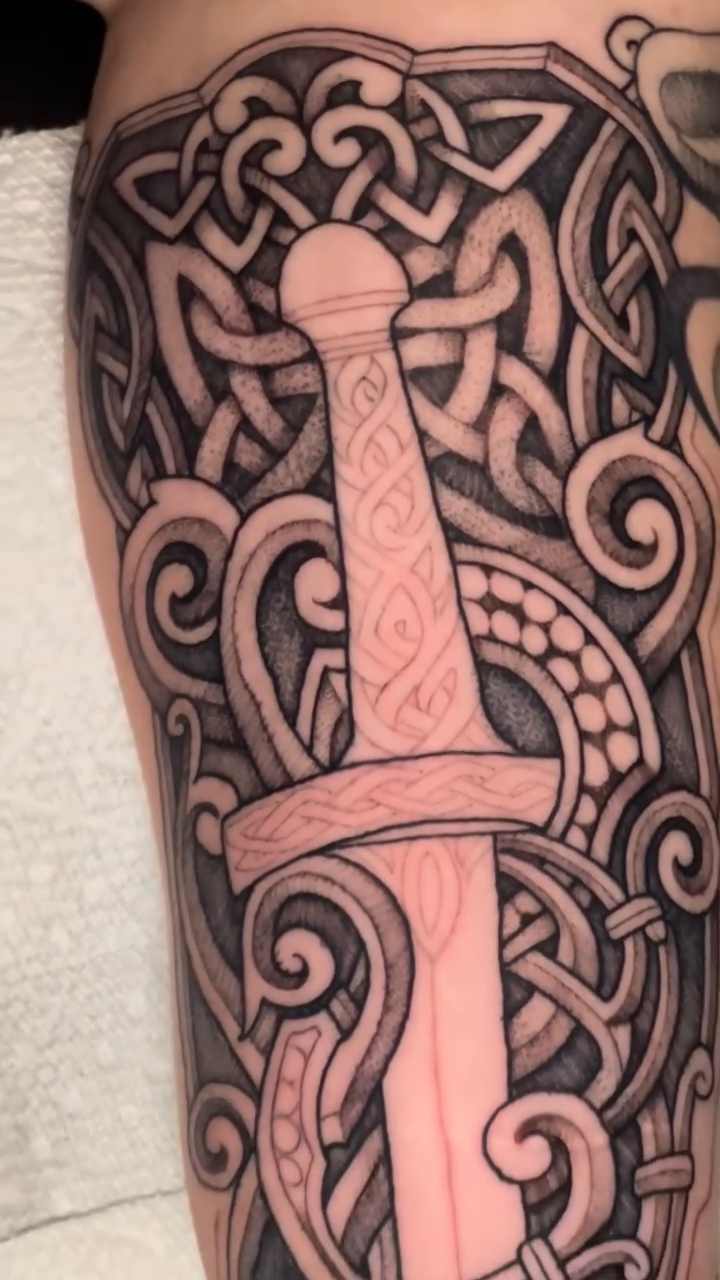Sword and celtic knotwork geometric tattoo by Ricky Myotte