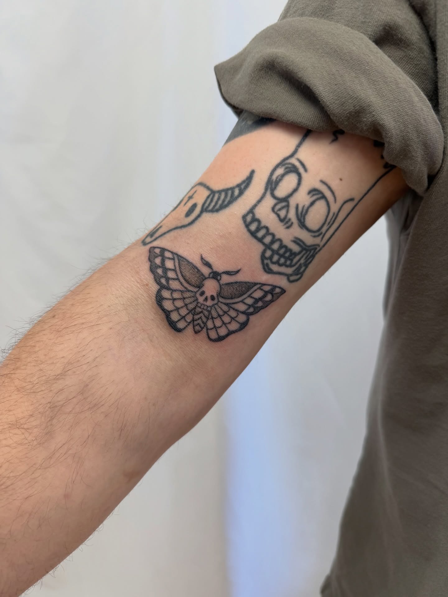 Skull moth black and grey tattoo on the forearm by Melia Mariko