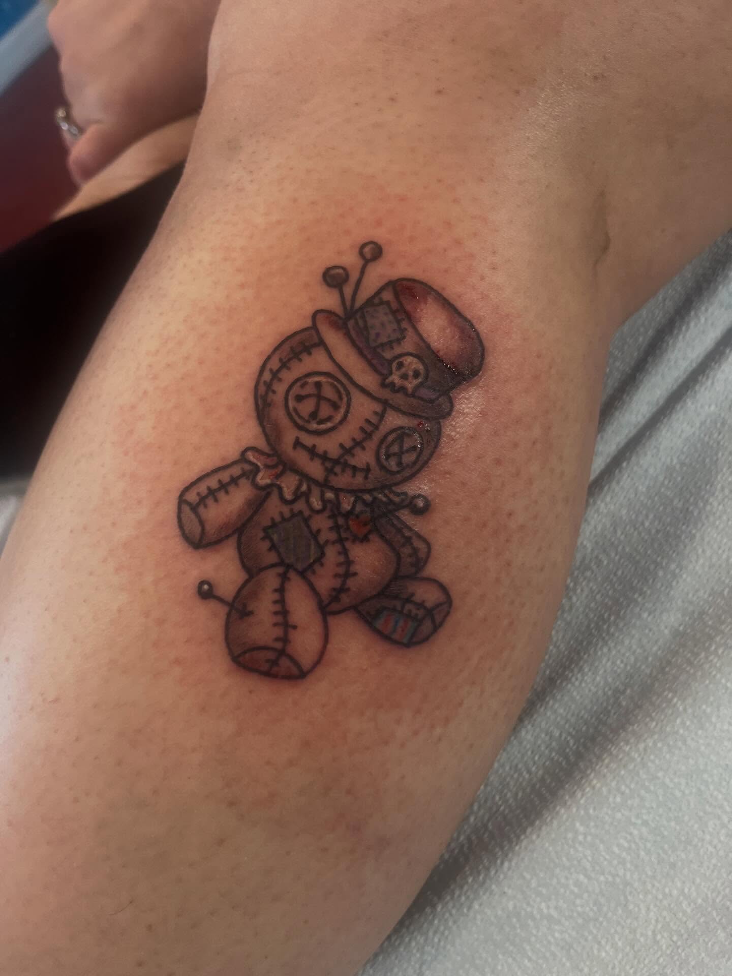 Voodoo doll black and grey tattoo on the forearm by Rafaela Lopez