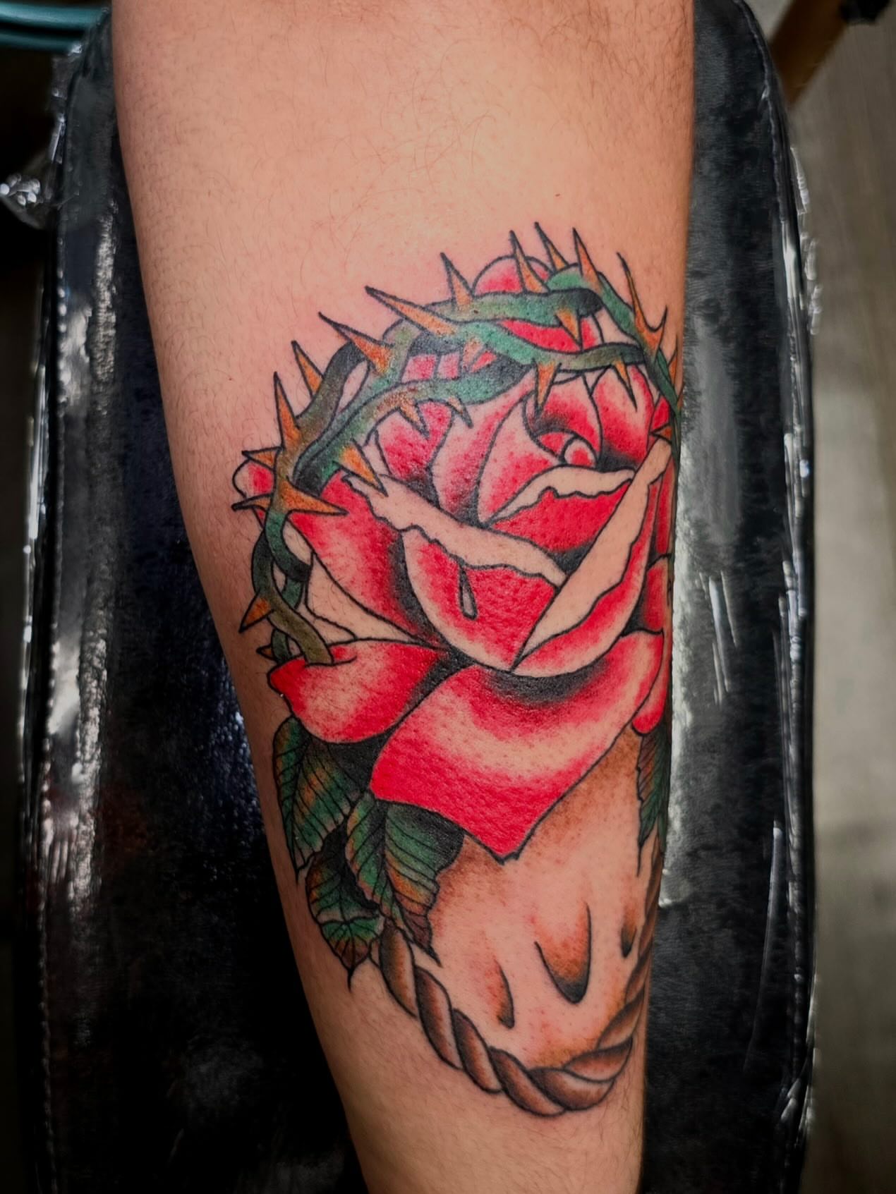 Rose with crown of thorns American traditional tattoo on the forearm by Columbus tattoo artist