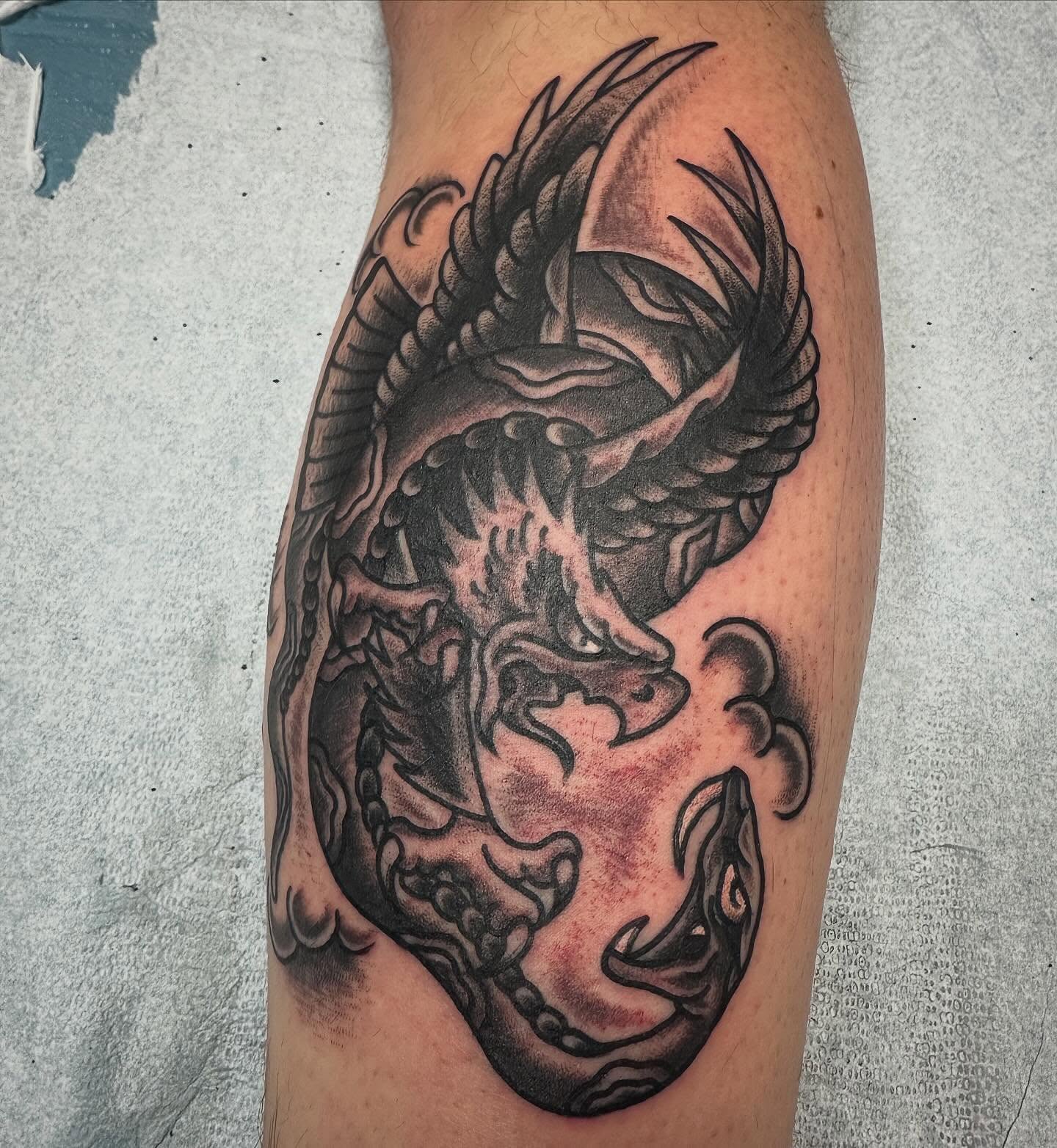 Dragon black and grey tattoo on the forearm by Devin Spenny