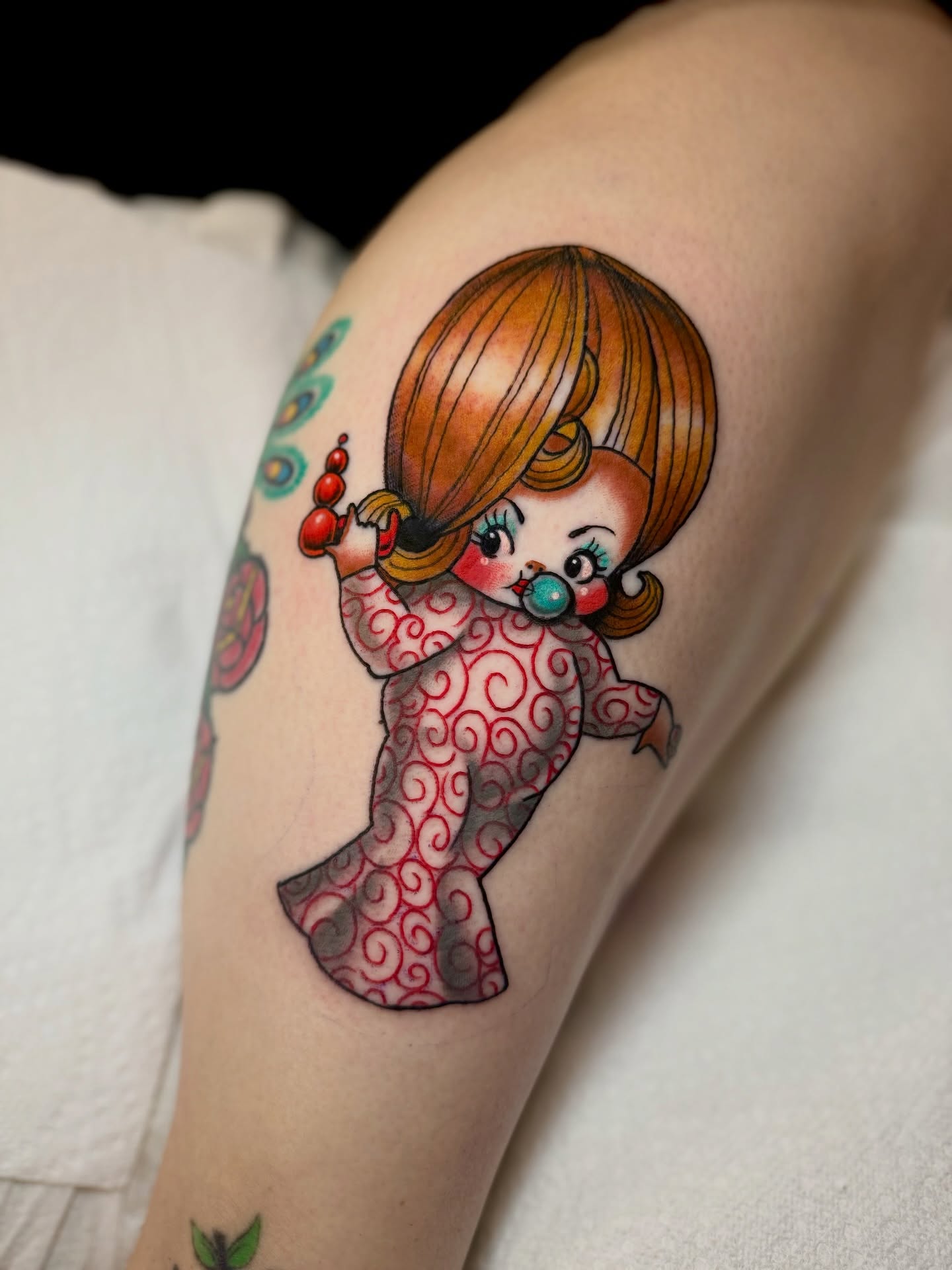 Doll American traditional tattoo on the forearm by Stacey Martin Smith