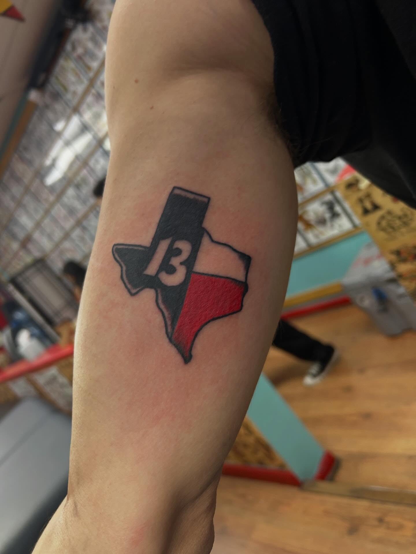 Texas state outline with number 13 American traditional tattoo on the forearm by Elizabeth Niederkorn