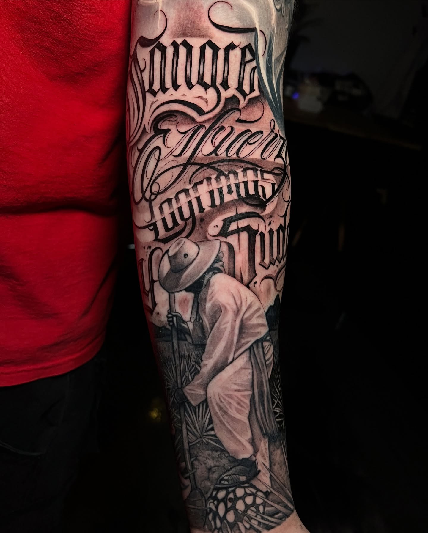 Farmer black and grey tattoo on the forearm by Lettering
