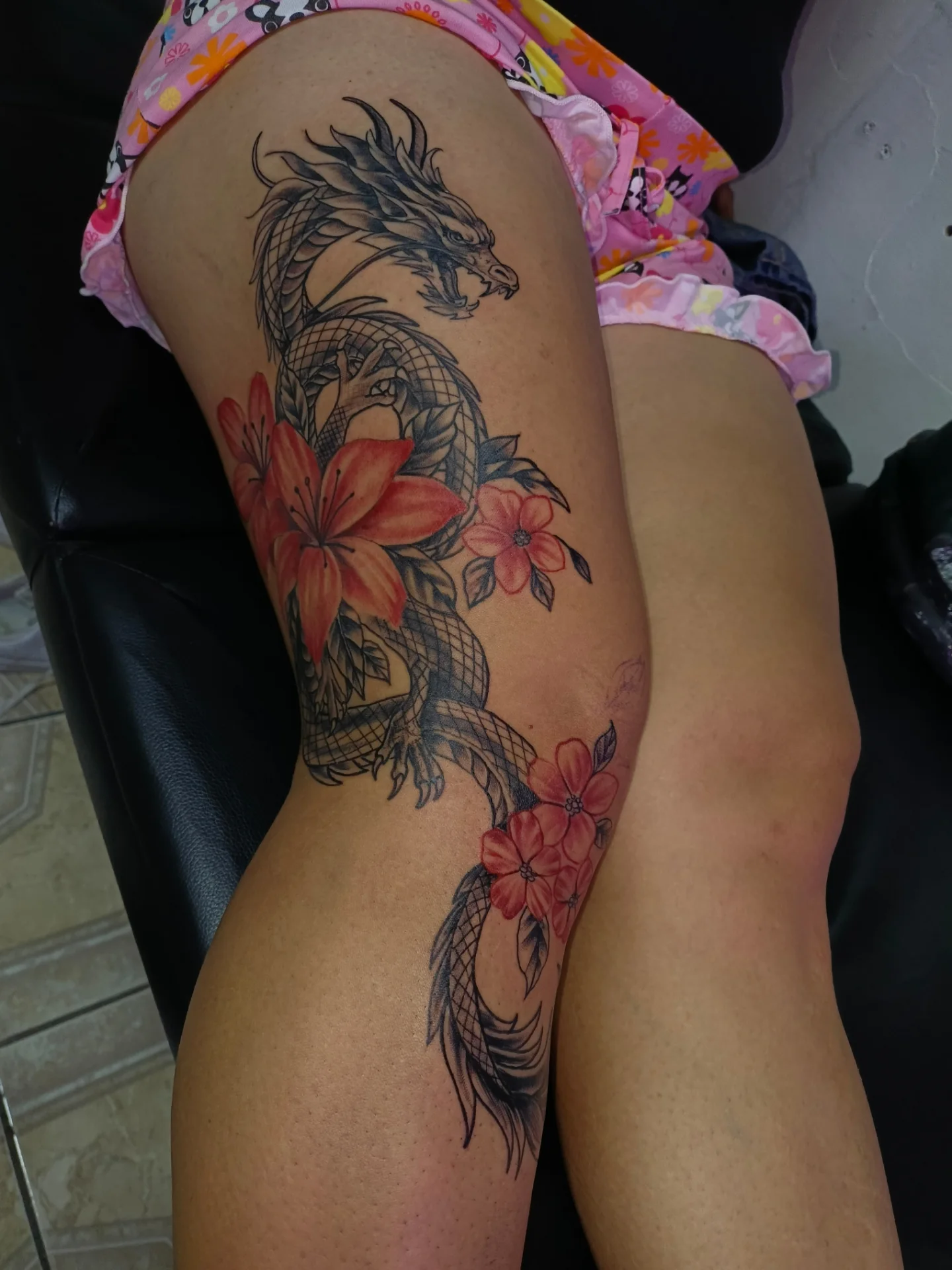 Dragon and flowers japanese irezumi tattoo on the thigh by Alexander Tattooink