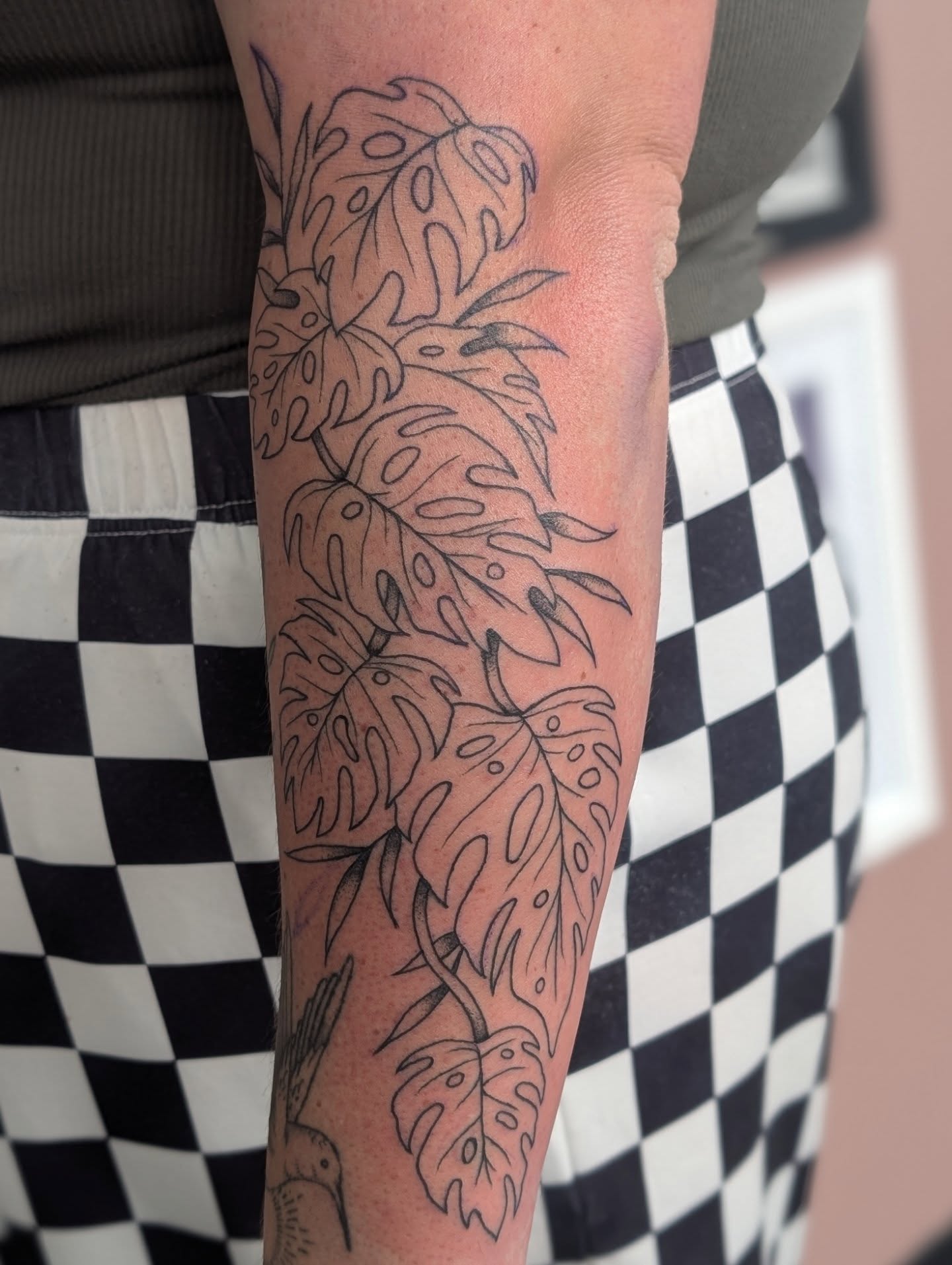 Monstera leaves black and grey tattoo on the forearm by Alexandria Green