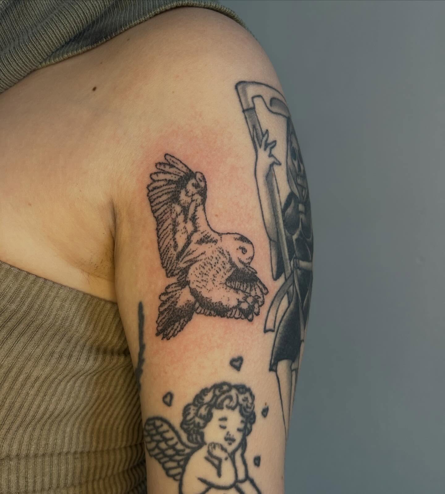 Angel and bird black and grey tattoo on the upper arm by ˙⋆✮⋆˙‧₊˚✧ sophie ✧˚₊‧˙⋆✮⋆˙