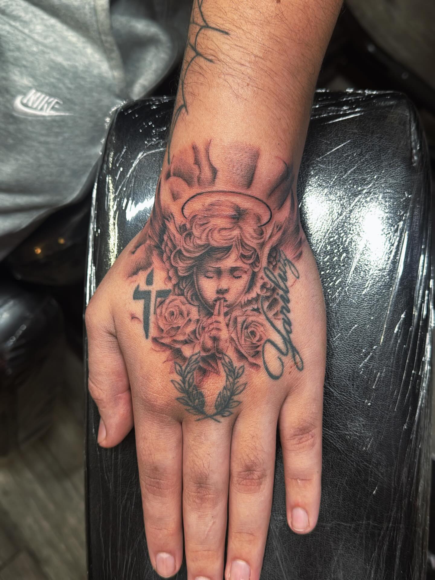 Angel with roses neo-traditional tattoo on the hand by πΎππππππππ