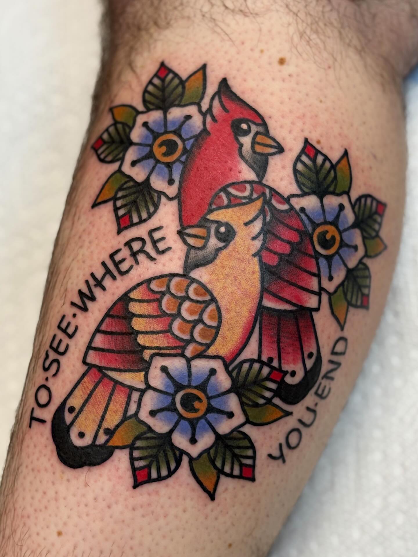 Cardinals and flowers American traditional tattoo on the forearm by Dakota Amato