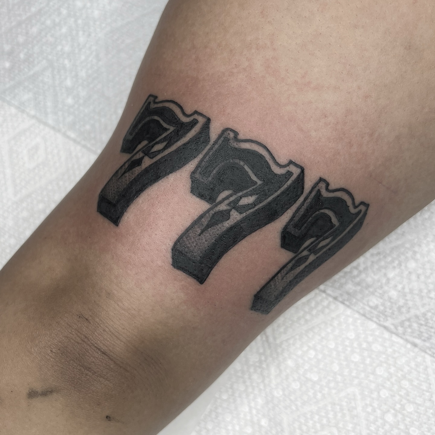 Numbers black and grey tattoo on the forearm by 𝑴𝑬𝑮𝑨𝑵 𝑪𝑳𝑰𝑭𝑻𝑶𝑵, Cincinnati, Ohio