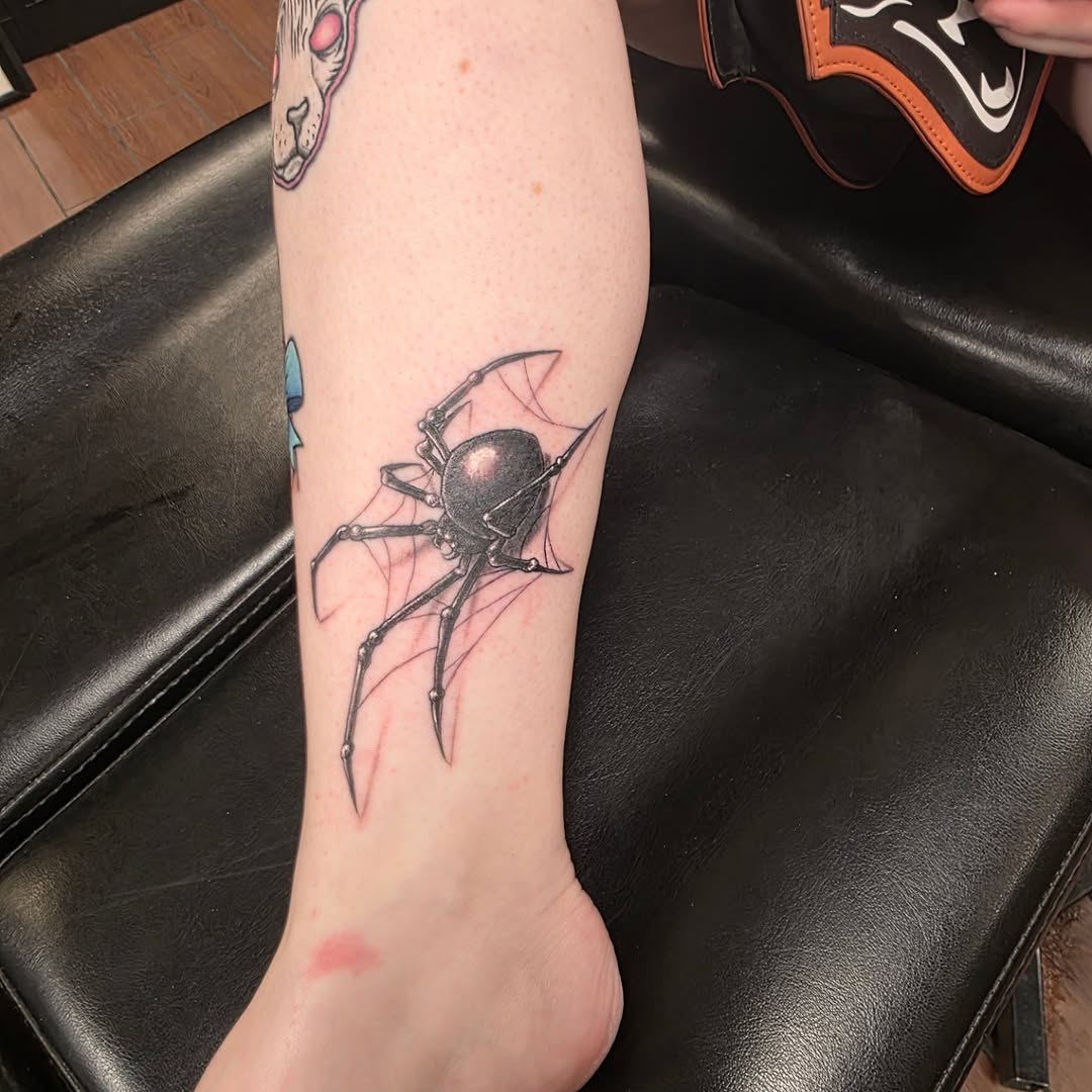 Black widow spider on web blackwork tattoo on the forearm by Jeff Frederick