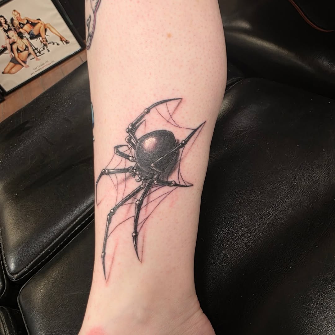 Black widow spider on web blackwork tattoo on the forearm by Jeff Frederick