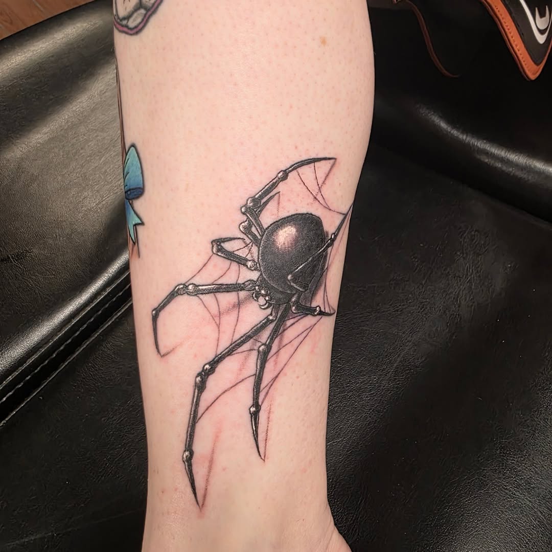 Black widow spider on web blackwork tattoo on the forearm by Jeff Frederick