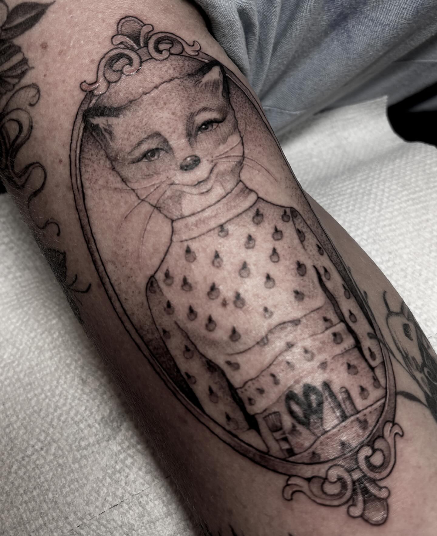 Cat in dress dotwork tattoo on the forearm by Lena Lawrence