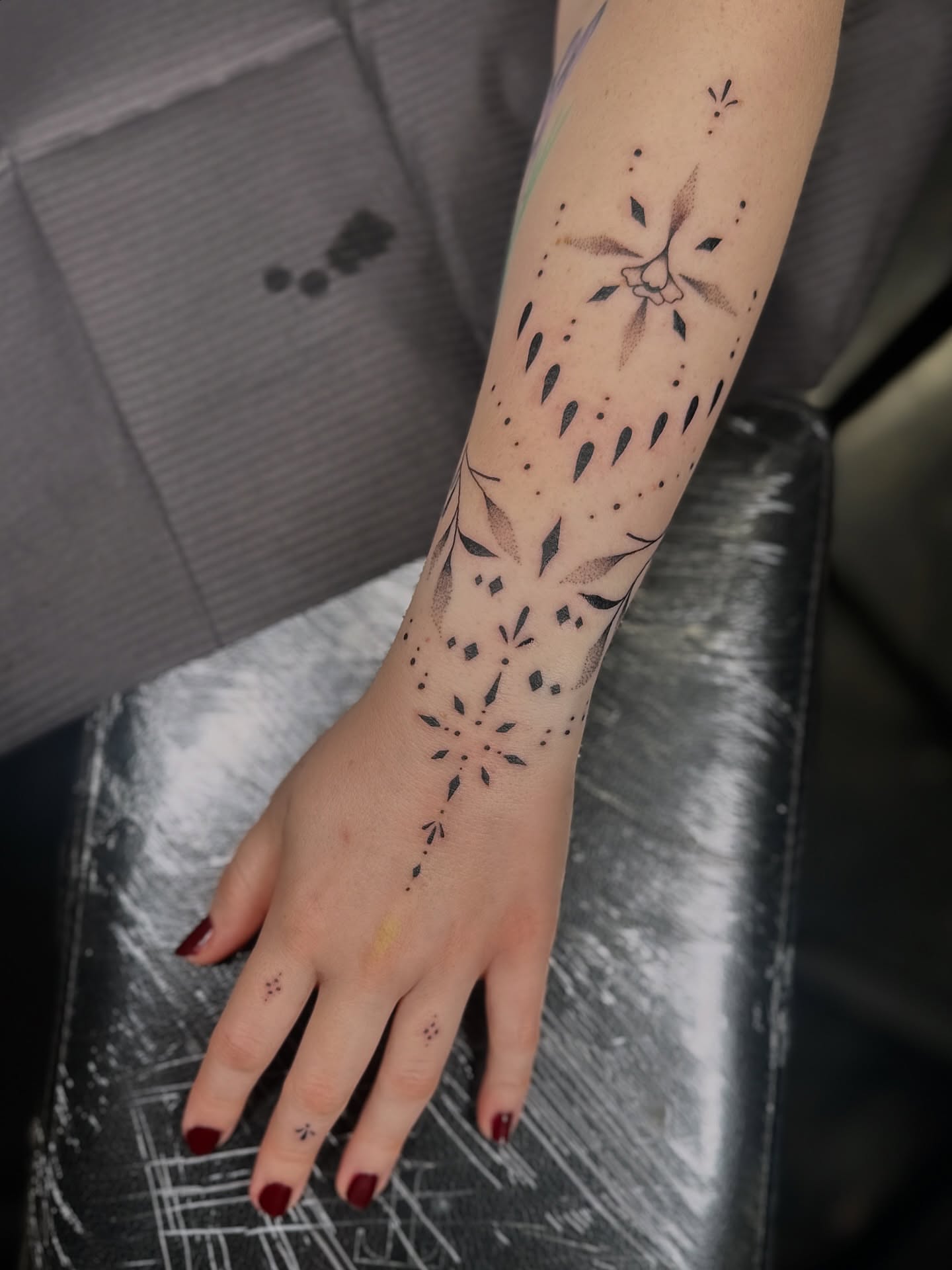 Geometric pattern dotwork tattoo on the forearm by Hayley Thomas
