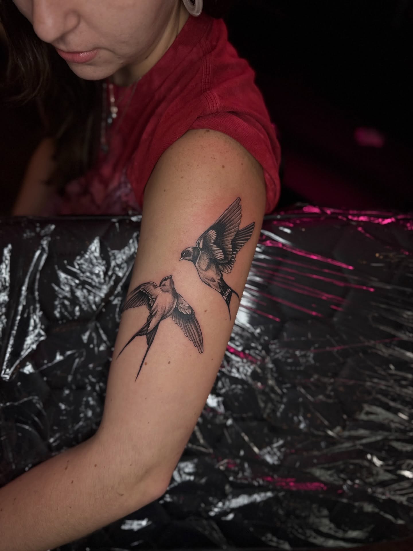 Swallows black and grey tattoo on the forearm by Honey