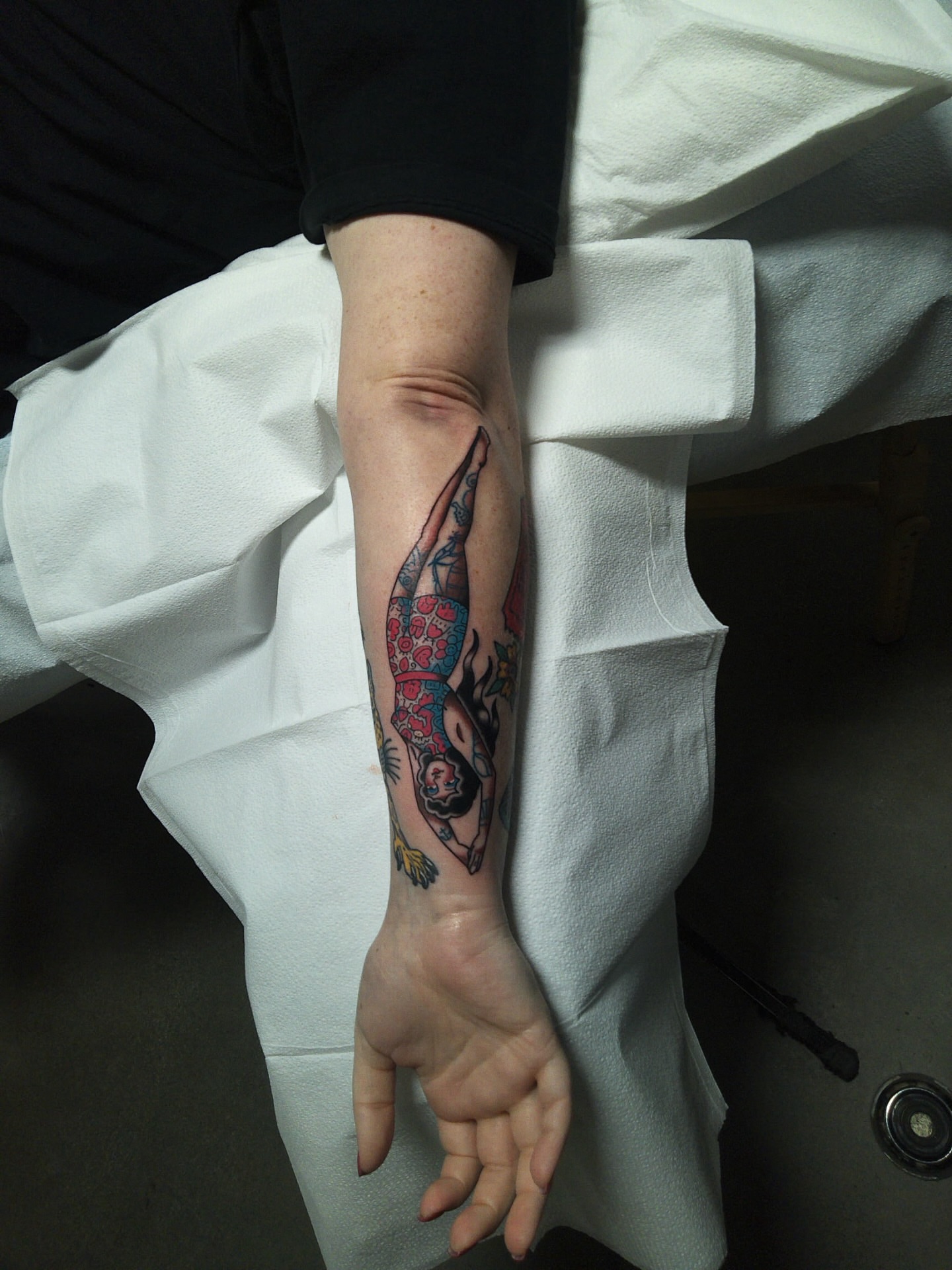 Woman diving American traditional tattoo on the forearm by Lauren Alexandra