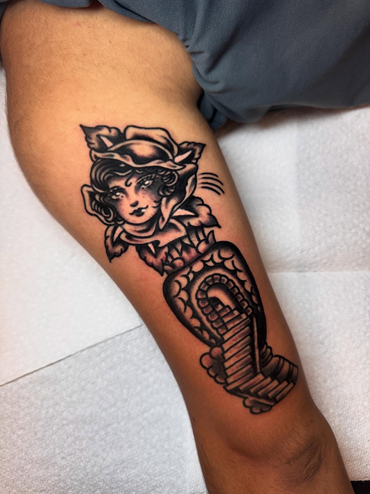 Woman with snake American traditional tattoo on the forearm by Jonathan Clapp, San Antonio, Texas