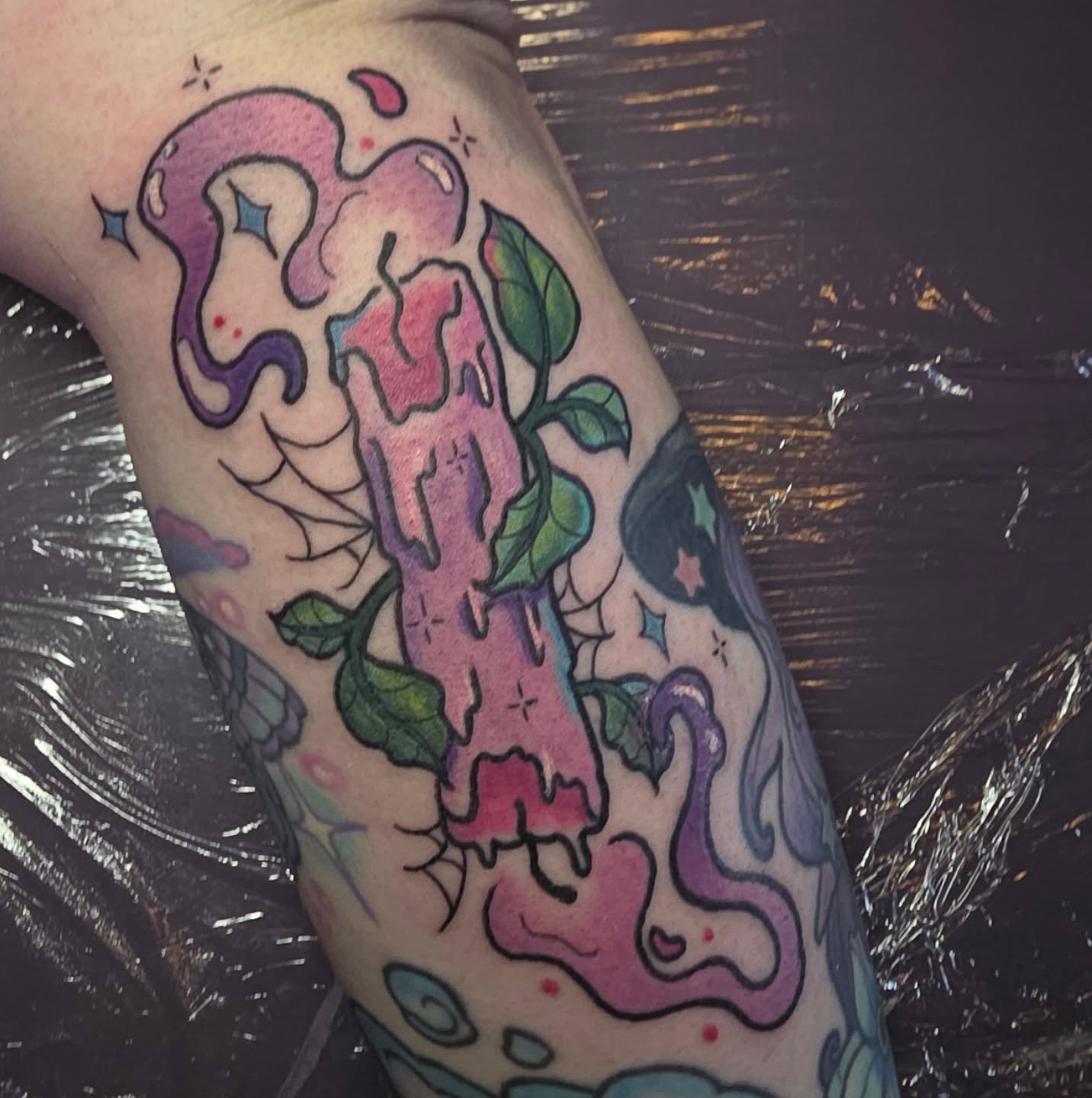Melting candle new school tattoo on the forearm by Kayla Williams