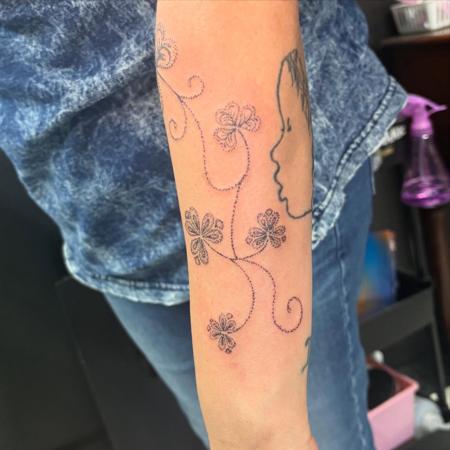 Flower vine with profile dotwork tattoo on the forearm by Joe ⋆₊⋆☢︎⁺₊⚠︎₊⋆