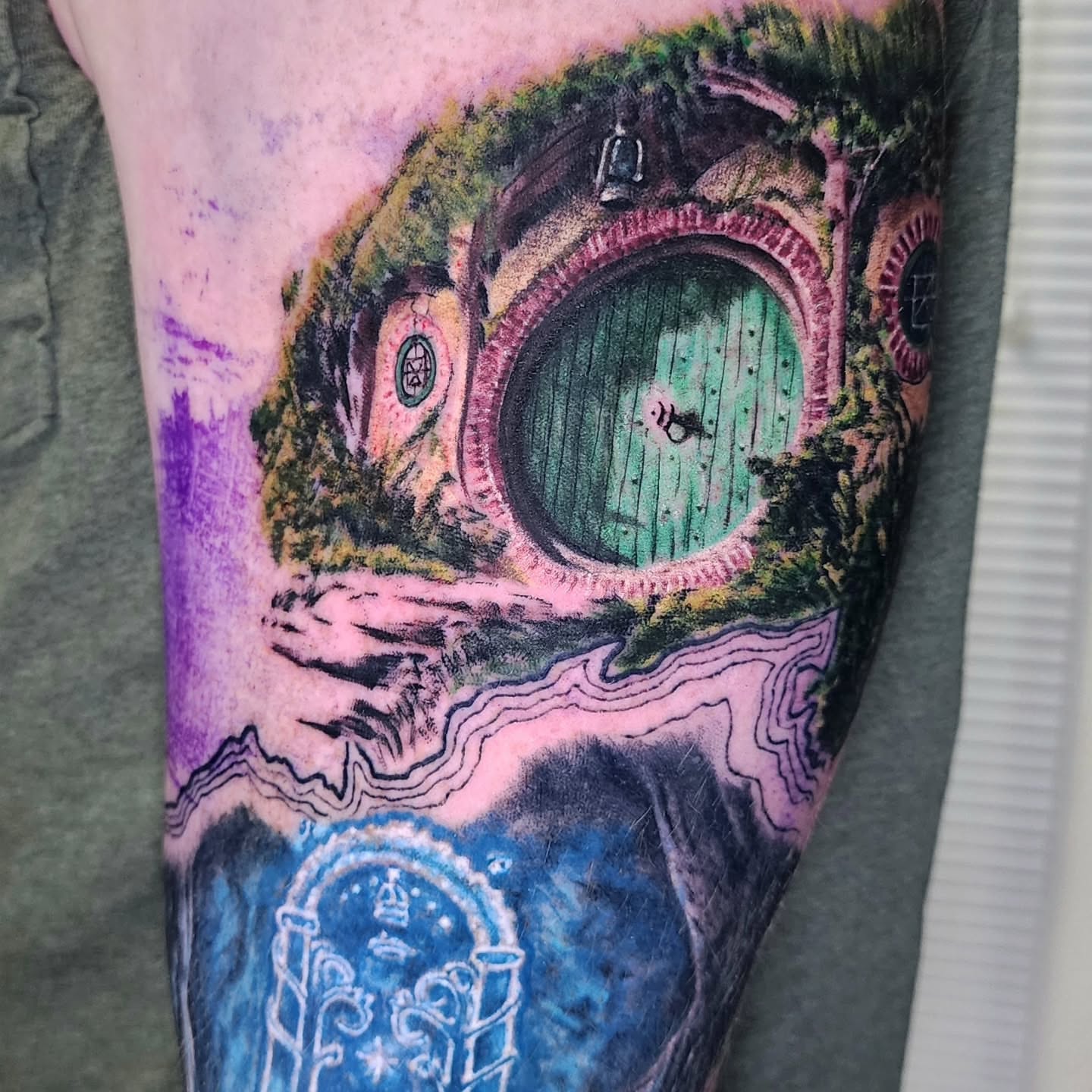 Hobbit house realism tattoo on the forearm by Zach Mullins