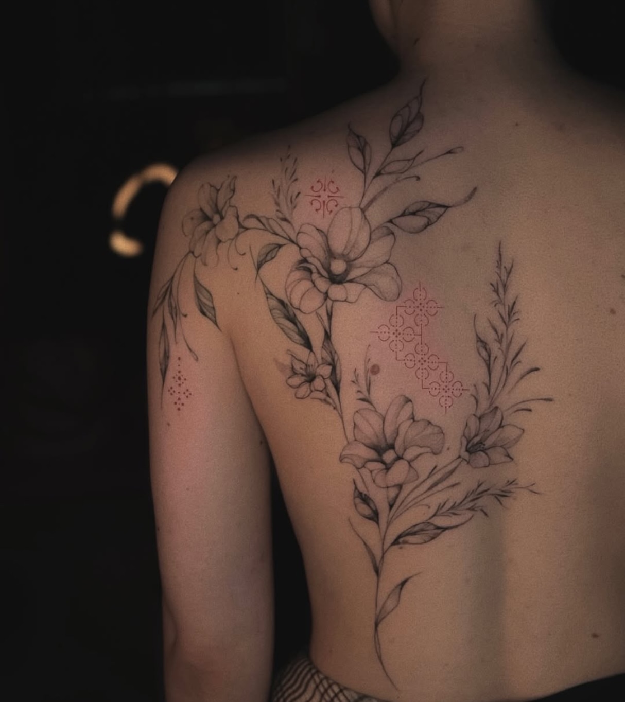 Floral arrangement black and grey tattoo on the shoulder by Nina Fedorchenko