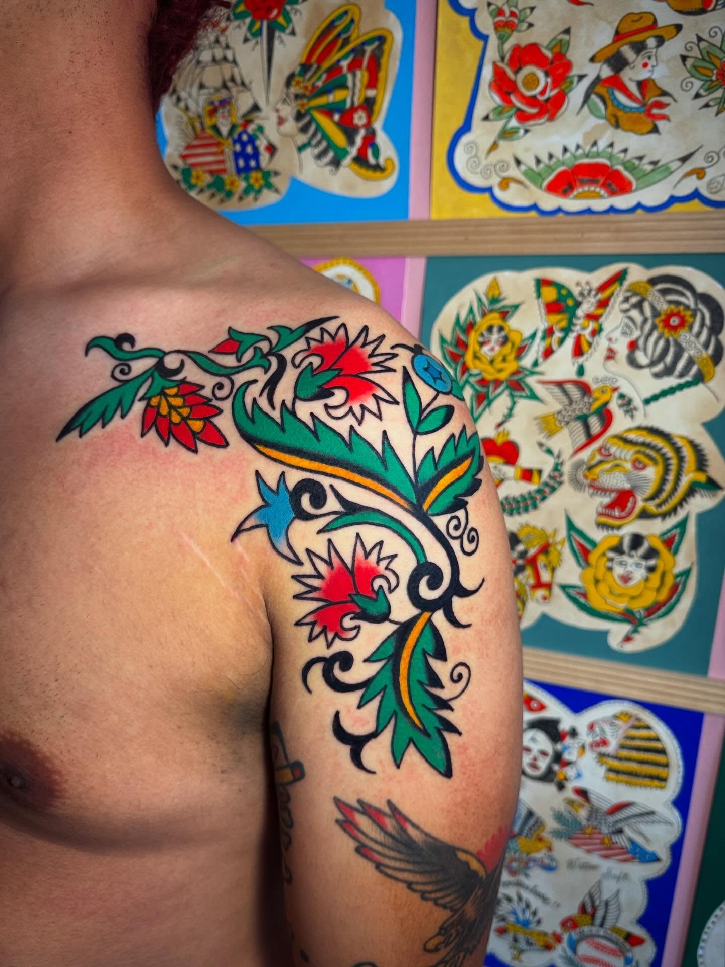 Floral design American traditional tattoo on the shoulder by Britt Kuechenmeister, Culver City, California