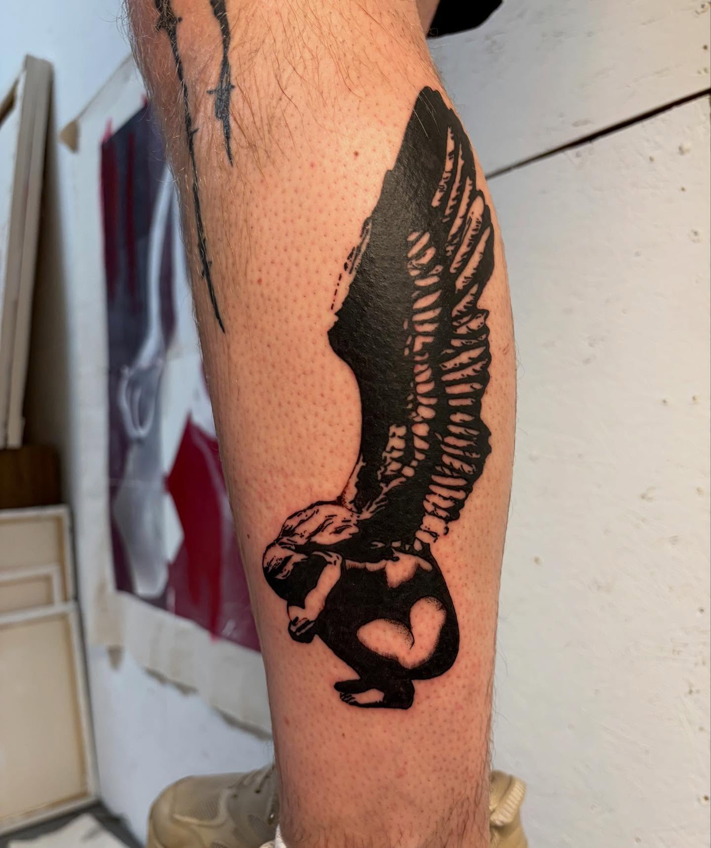 Winged figure black and grey tattoo on the forearm by bisabuelita