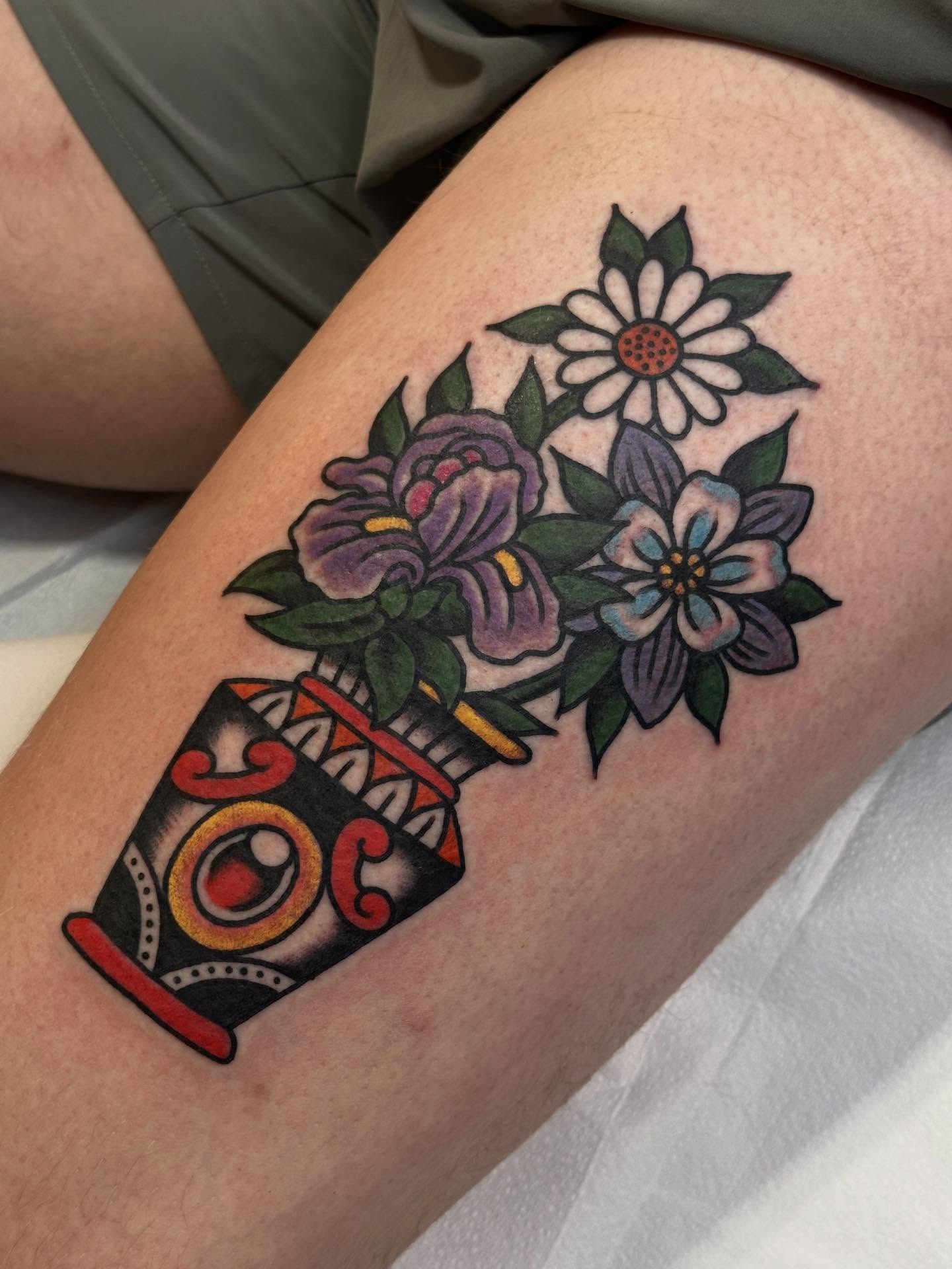 Flower bouquet American traditional tattoo on the thigh by Cody Woolard, Seymour, Tennessee