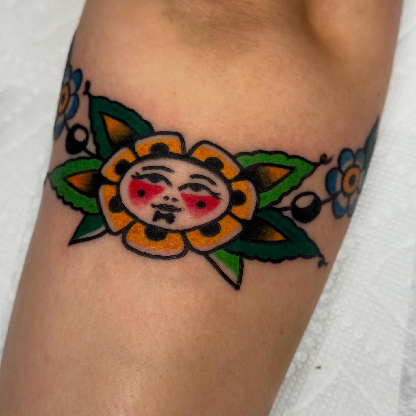 Sun face American traditional tattoo on the forearm by JoJo Benton