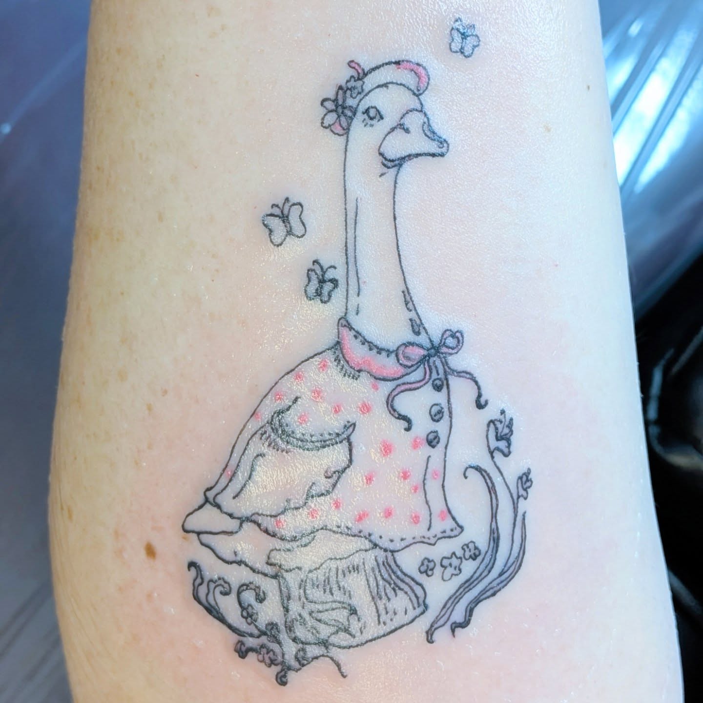Goose in dress illustrative tattoo on the forearm by Ryan