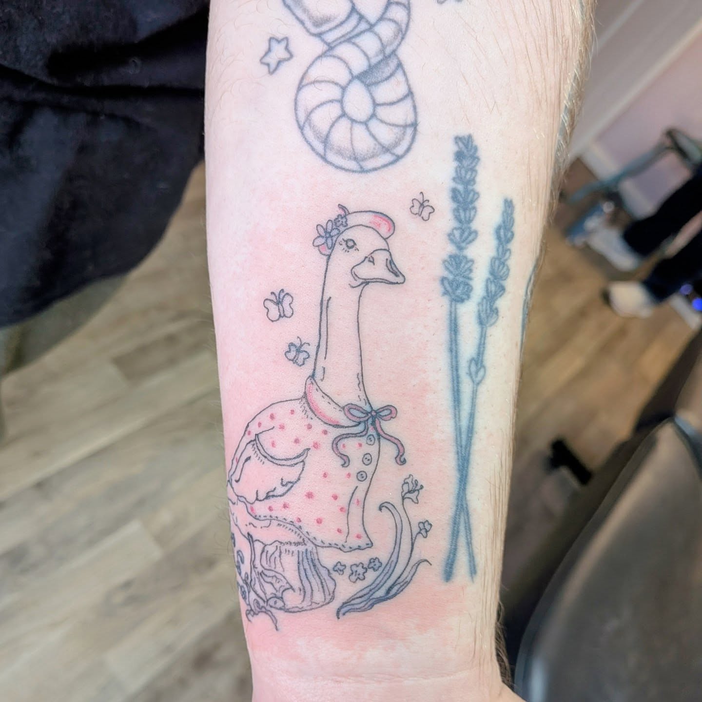 Goose with lavender new school tattoo on the forearm by Ryan