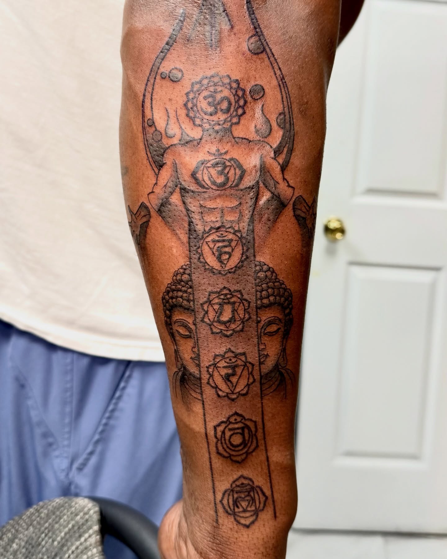 Chakra system black and grey tattoo on the forearm by Eden Allen