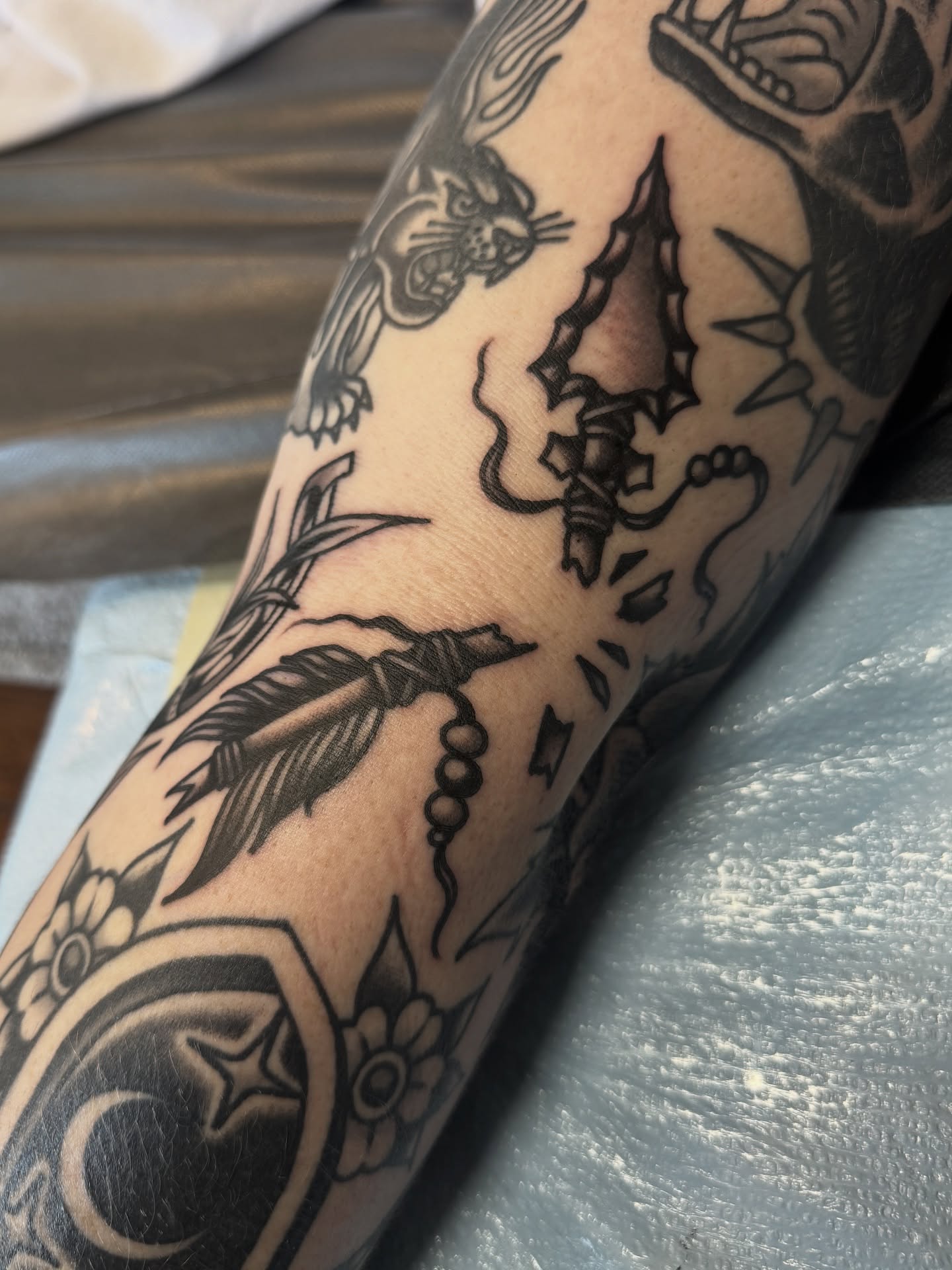 Bird and feather American traditional tattoo on the forearm by Nicholas Tidler